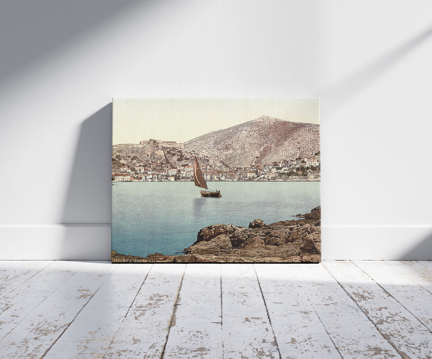 A picture of Lesina, from the sea, Dalmatia, Austro-Hungary, a mockup of the print leaning against a wall