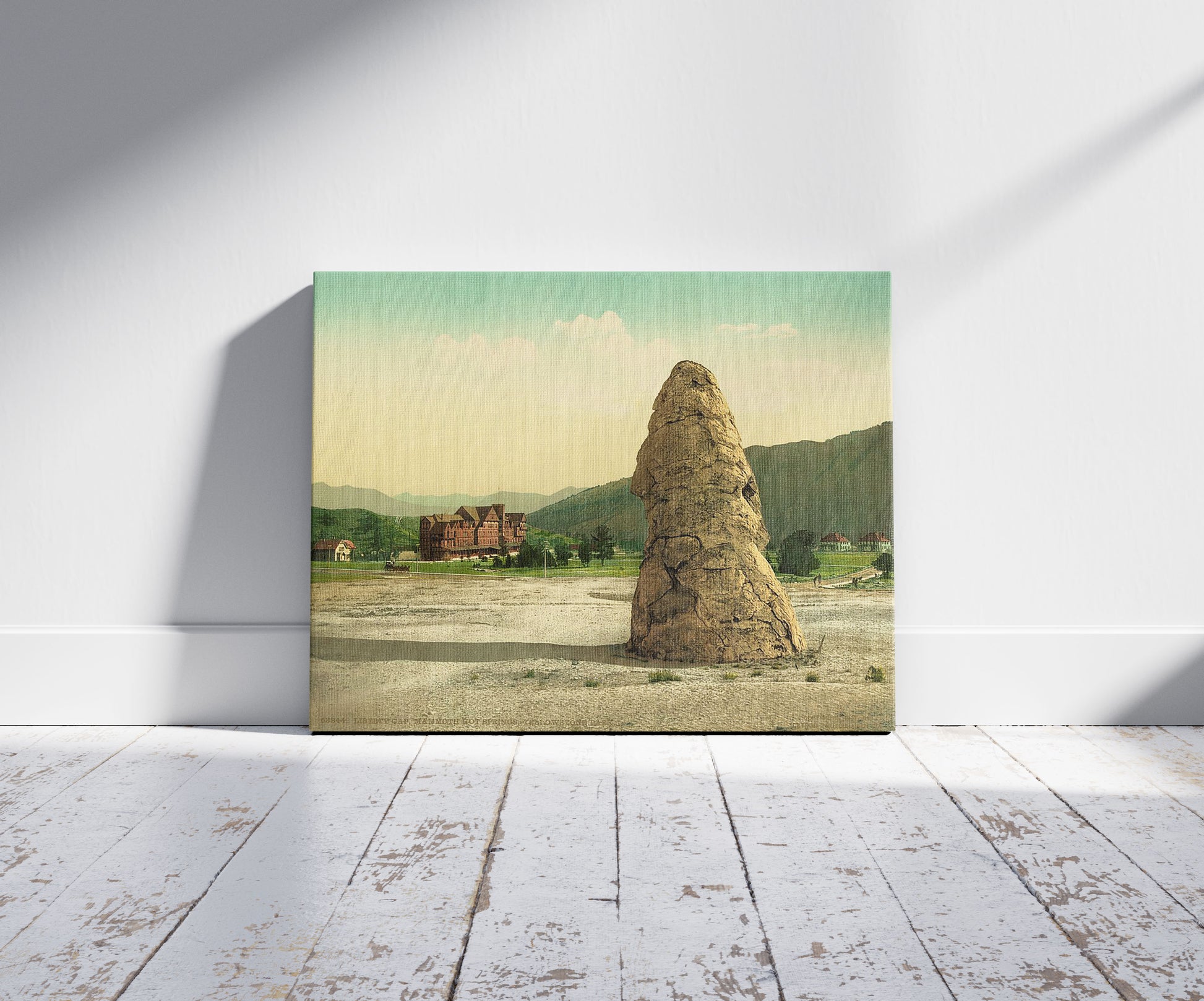 A picture of Liberty Cap, Mammoth Hot Springs, Yellowstone Park, a mockup of the print leaning against a wall