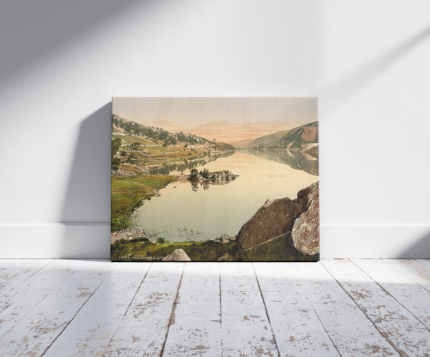 A picture of Llanberis and Lyn (i.e., Llyn) Peris, Wales, a mockup of the print leaning against a wall