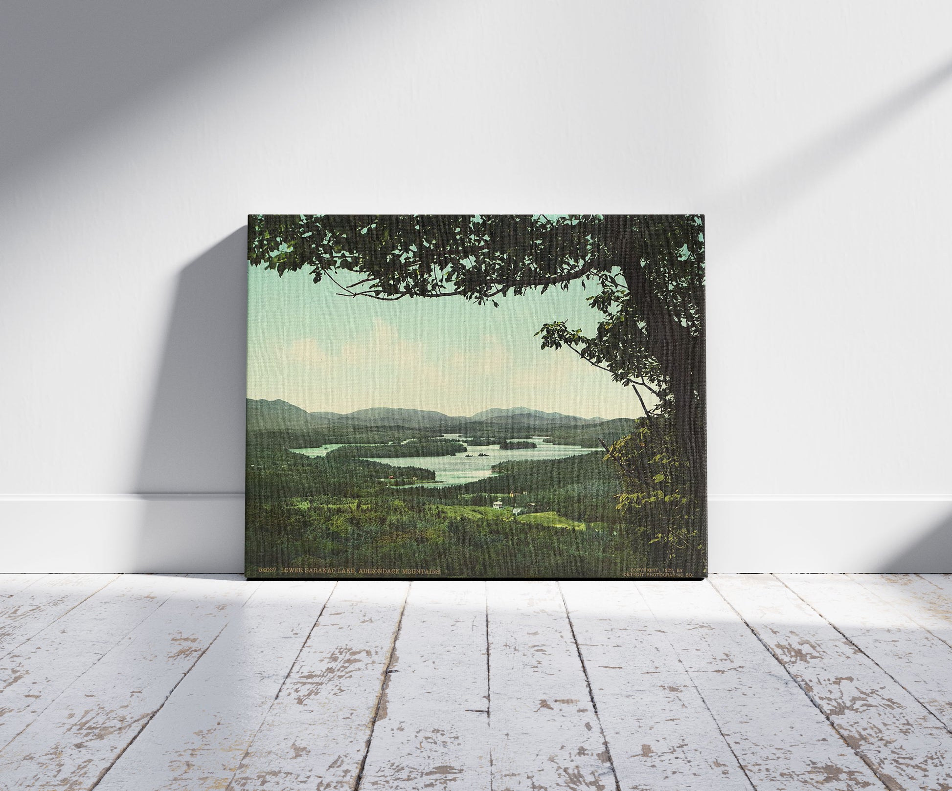 A picture of Lower Saranac Lake, Adirondack Mountains, a mockup of the print leaning against a wall