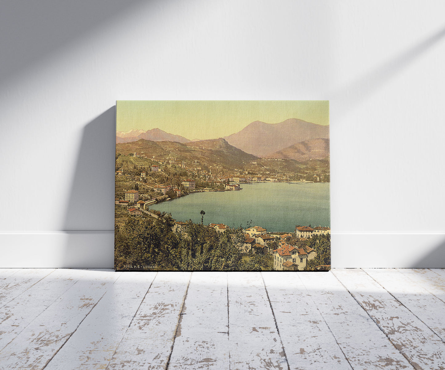 A picture of Lugano, from San Salvatore, Tessin, Switzerland, a mockup of the print leaning against a wall