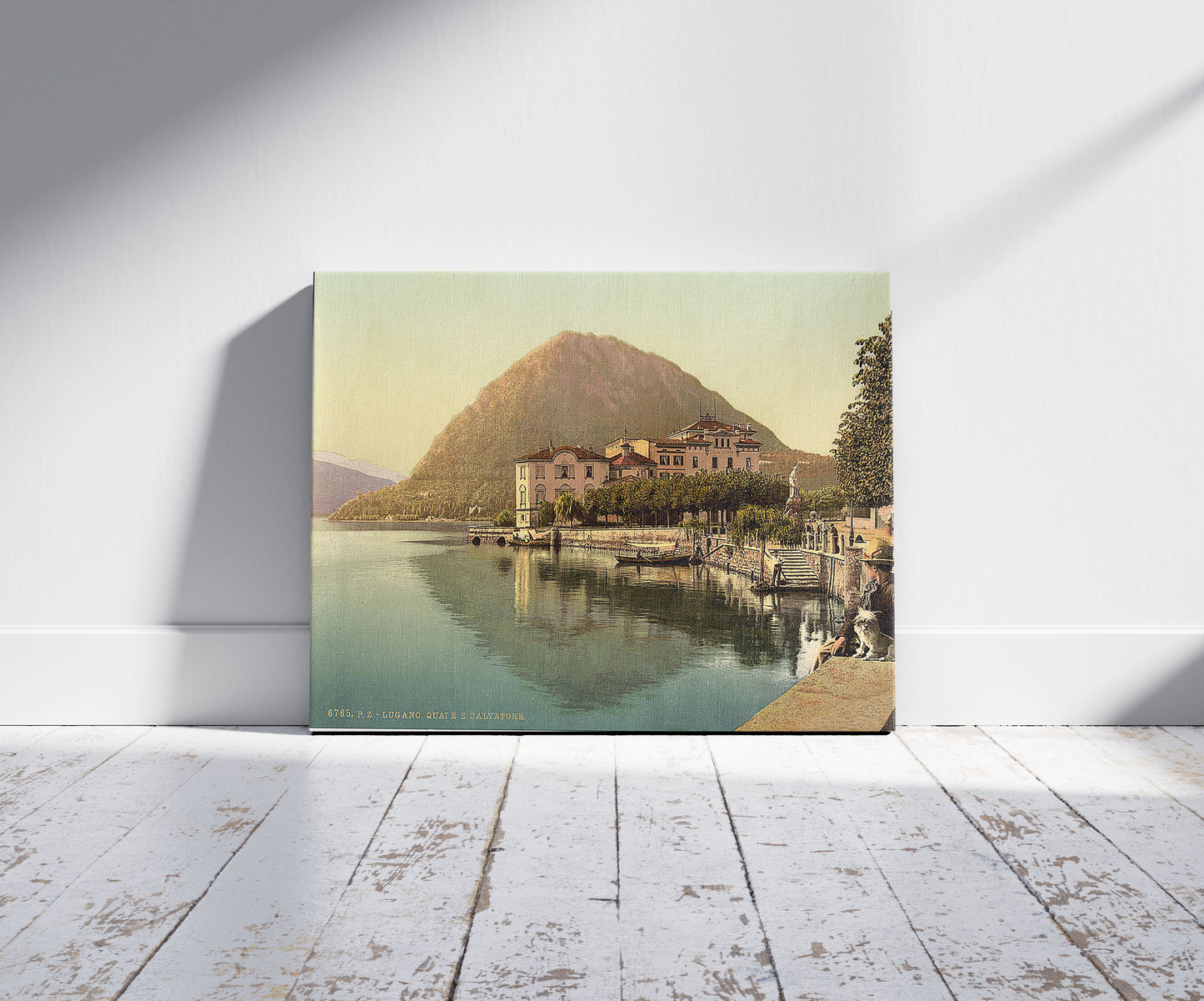 A picture of Lugano, the quay, and San Salvatore, Tessin, Switzerland, a mockup of the print leaning against a wall