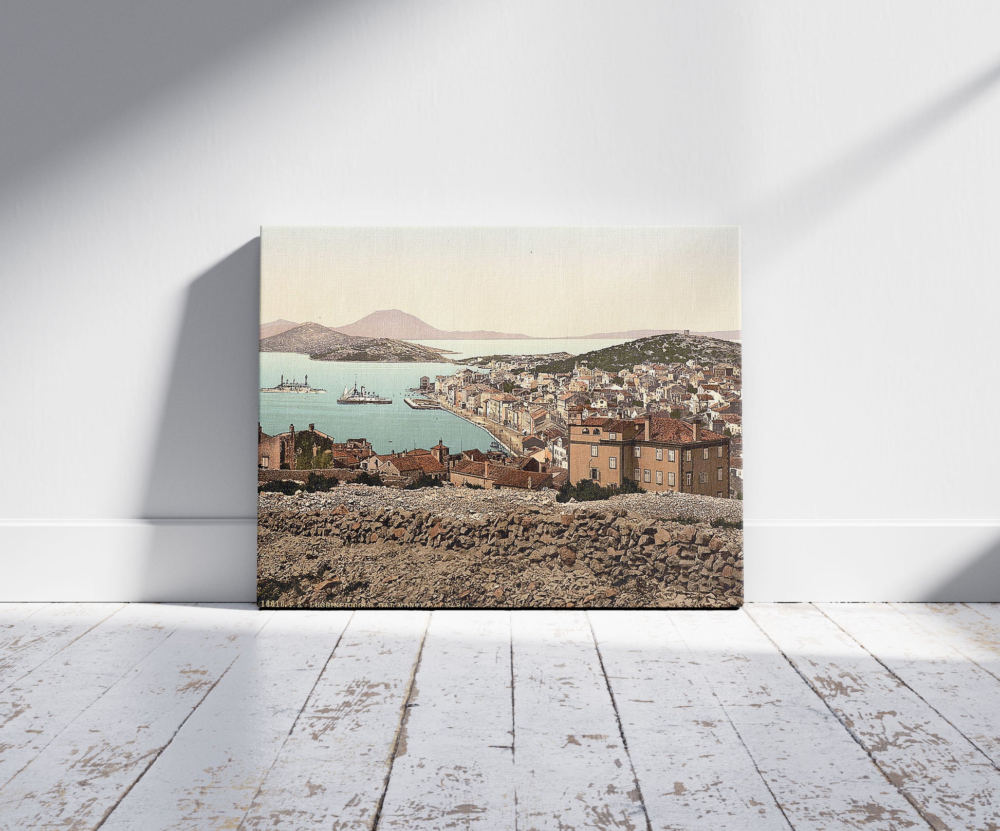 A picture of Lussin-Piccolo (i.e., Lussinpiccolo), from Monte Calavario, Istria, Austro-Hungary, a mockup of the print leaning against a wall