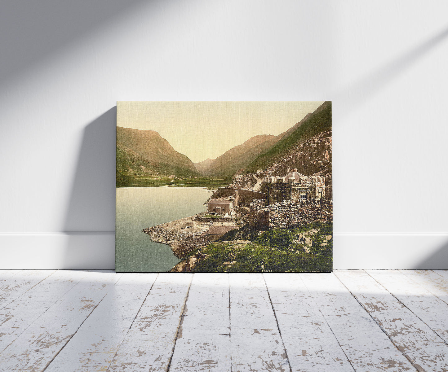 A picture of Lyn (i.e,. Llyn) Peris Pass, Llanberis, Wales, a mockup of the print leaning against a wall