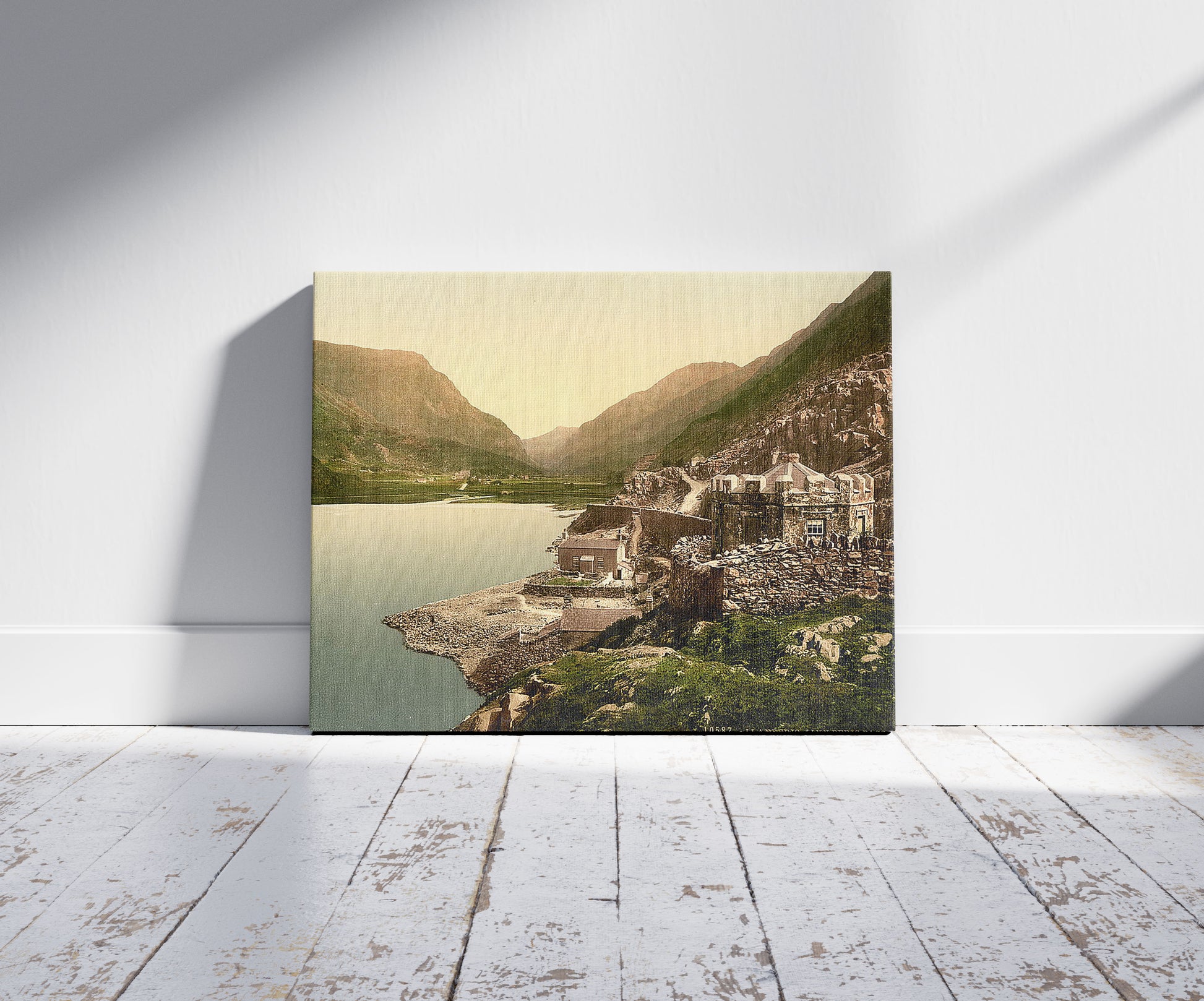 A picture of Lyn (i.e,. Llyn) Peris Pass, Llanberis, Wales, a mockup of the print leaning against a wall
