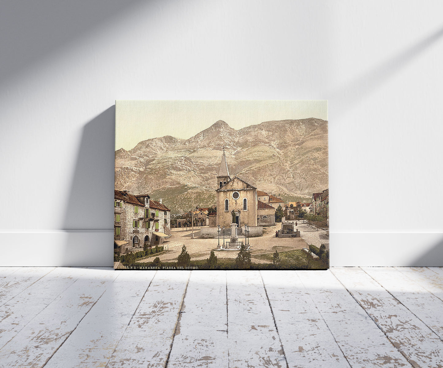 A picture of Makarska, Cathedral Square, Dalmatia, Austro-Hungary, a mockup of the print leaning against a wall