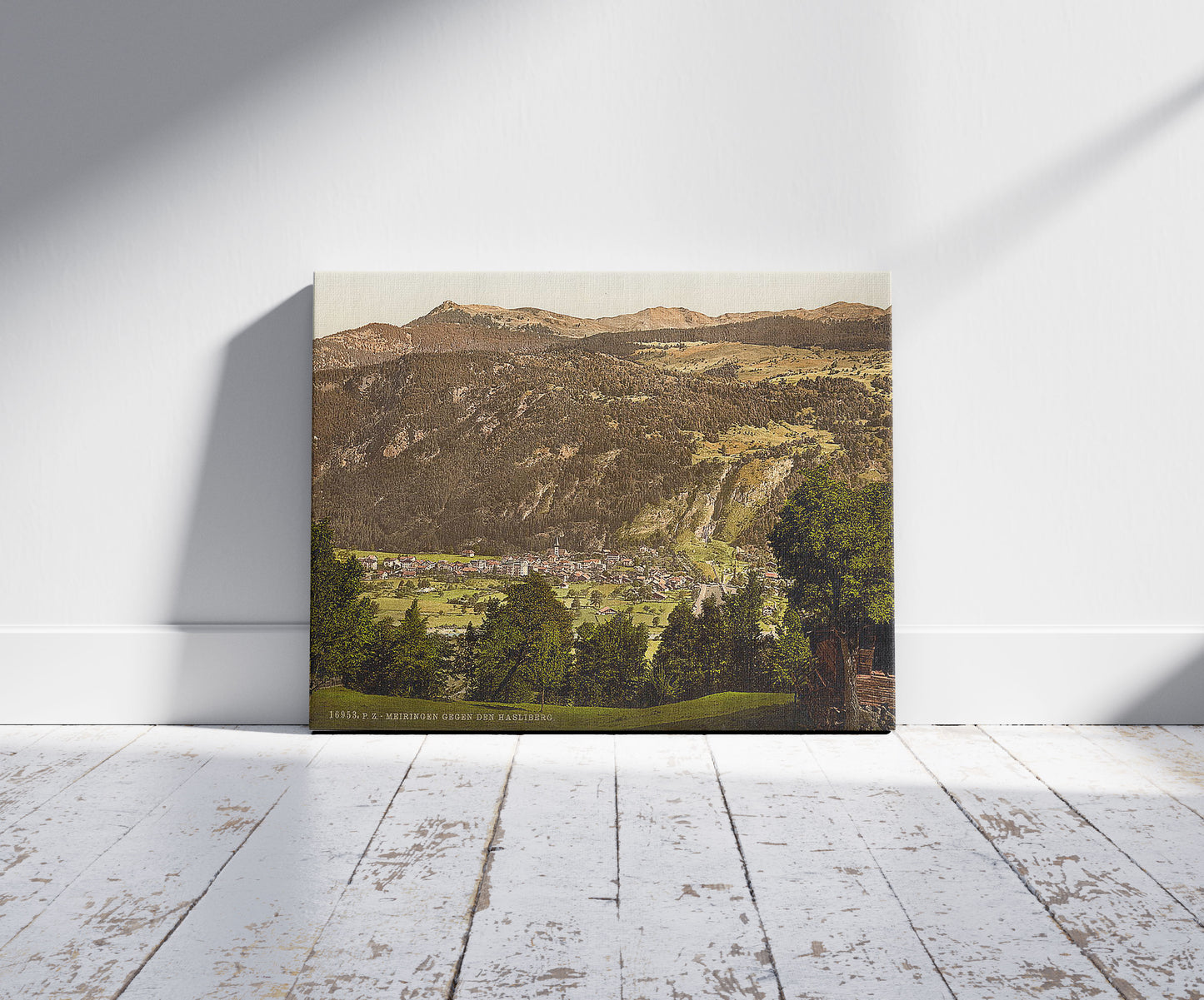 A picture of Meirngen, looking towards the Hasliberg, Bernese Oberland, Switzerland, a mockup of the print leaning against a wall