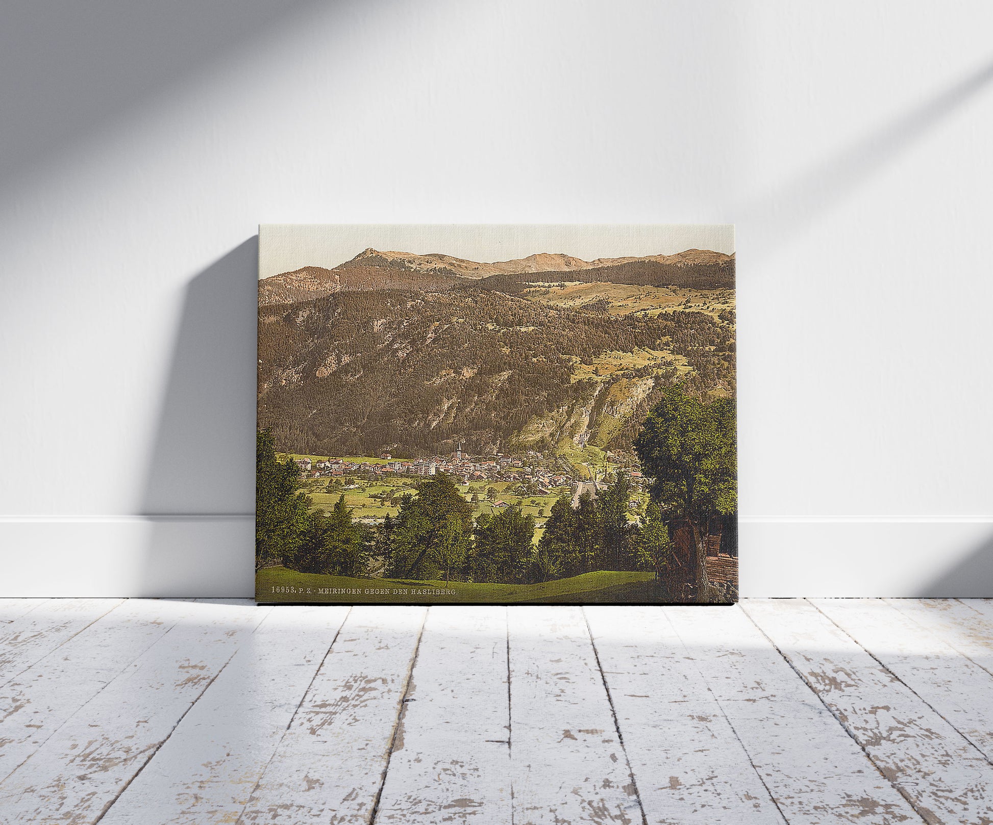 A picture of Meirngen, looking towards the Hasliberg, Bernese Oberland, Switzerland, a mockup of the print leaning against a wall