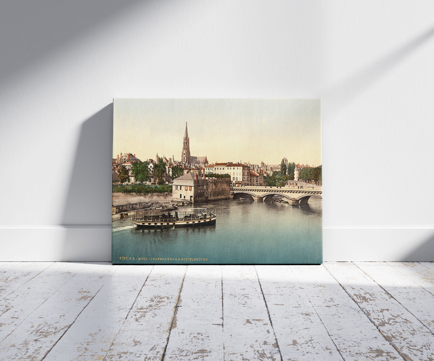A picture of Middle Bridge, Metz, Alsace Lorraine, Germany, a mockup of the print leaning against a wall