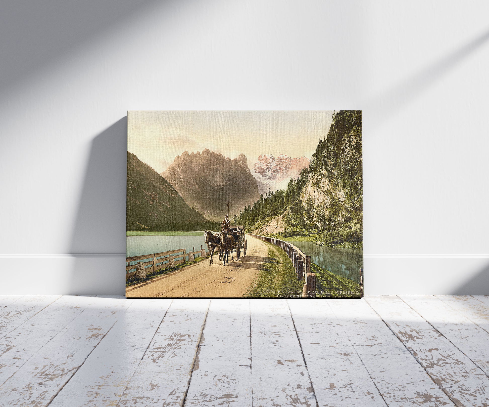 A picture of Monte Cristallo and Mont Popena, Ampezzostrasse with Durrensee, Tyrol, Austro-Hungary, a mockup of the print leaning against a wall
