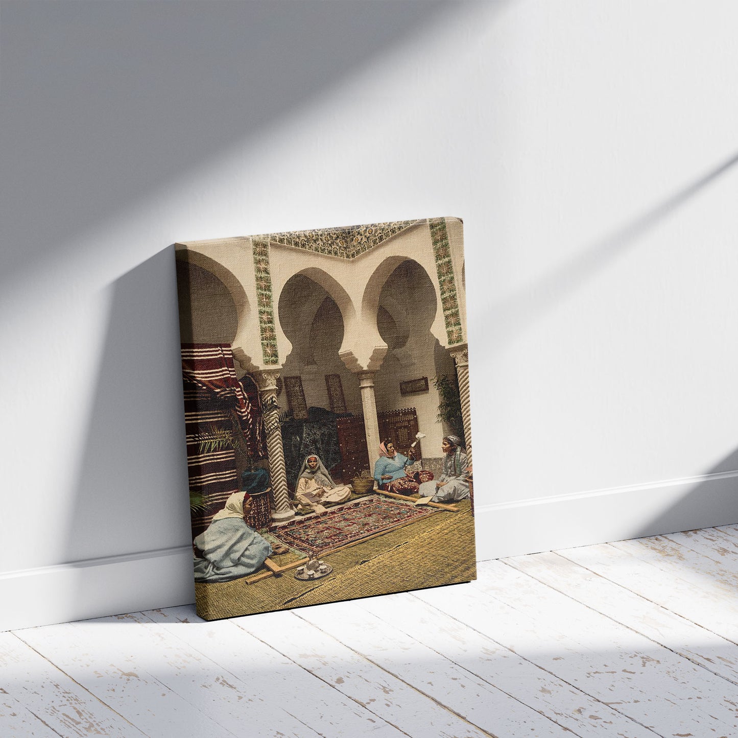 A picture of Moorish women making Arab carpets, Algiers, Algeria, a mockup of the print leaning against a wall