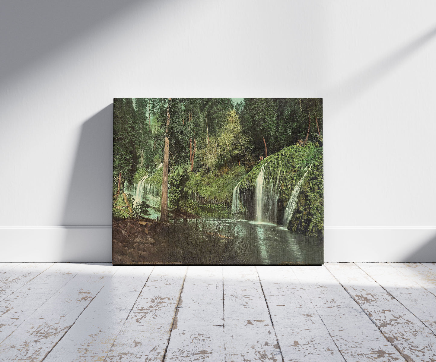 A picture of Mossbrae Falls, California, a mockup of the print leaning against a wall