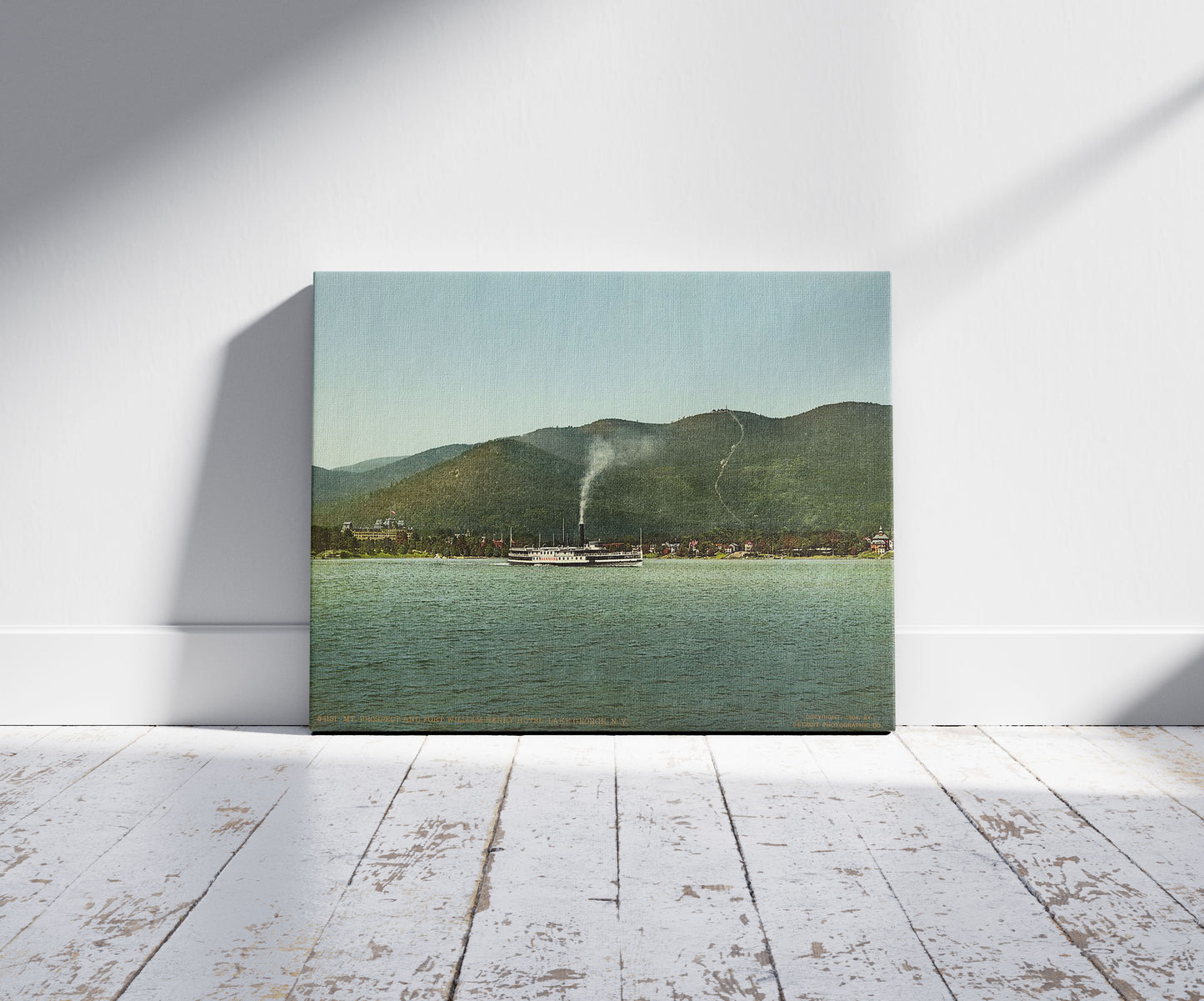 A picture of Mt. Prospect and Fort William Henry Hotel, Lake George, N.Y., a mockup of the print leaning against a wall