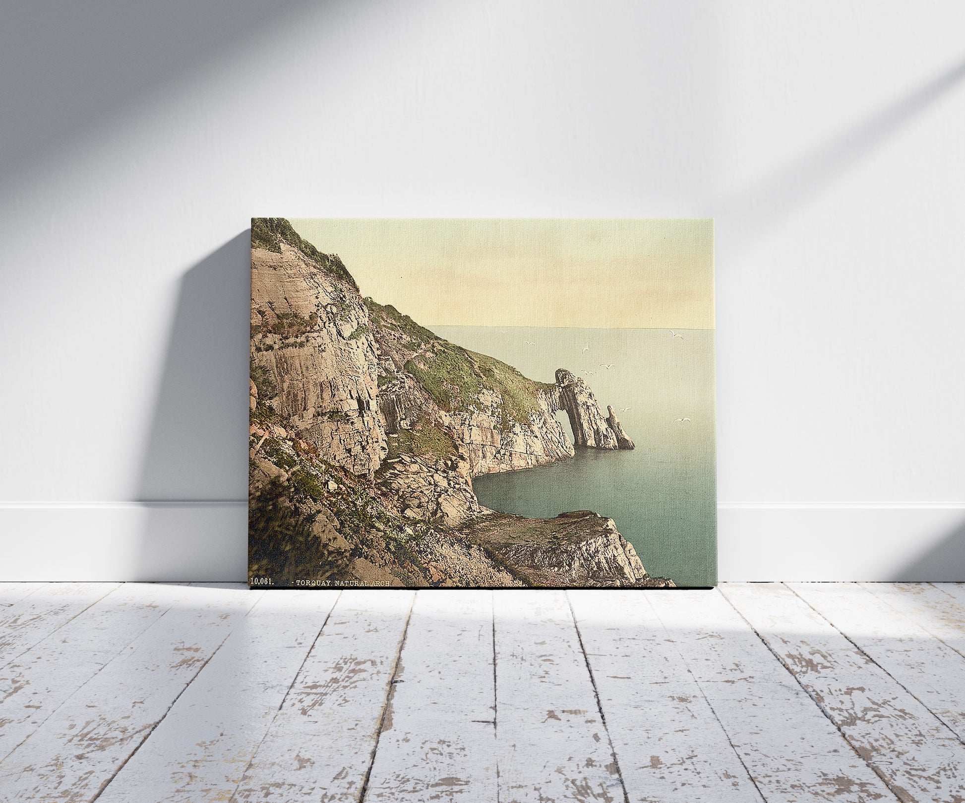 A picture of Natural Arch, Torquay, England, a mockup of the print leaning against a wall