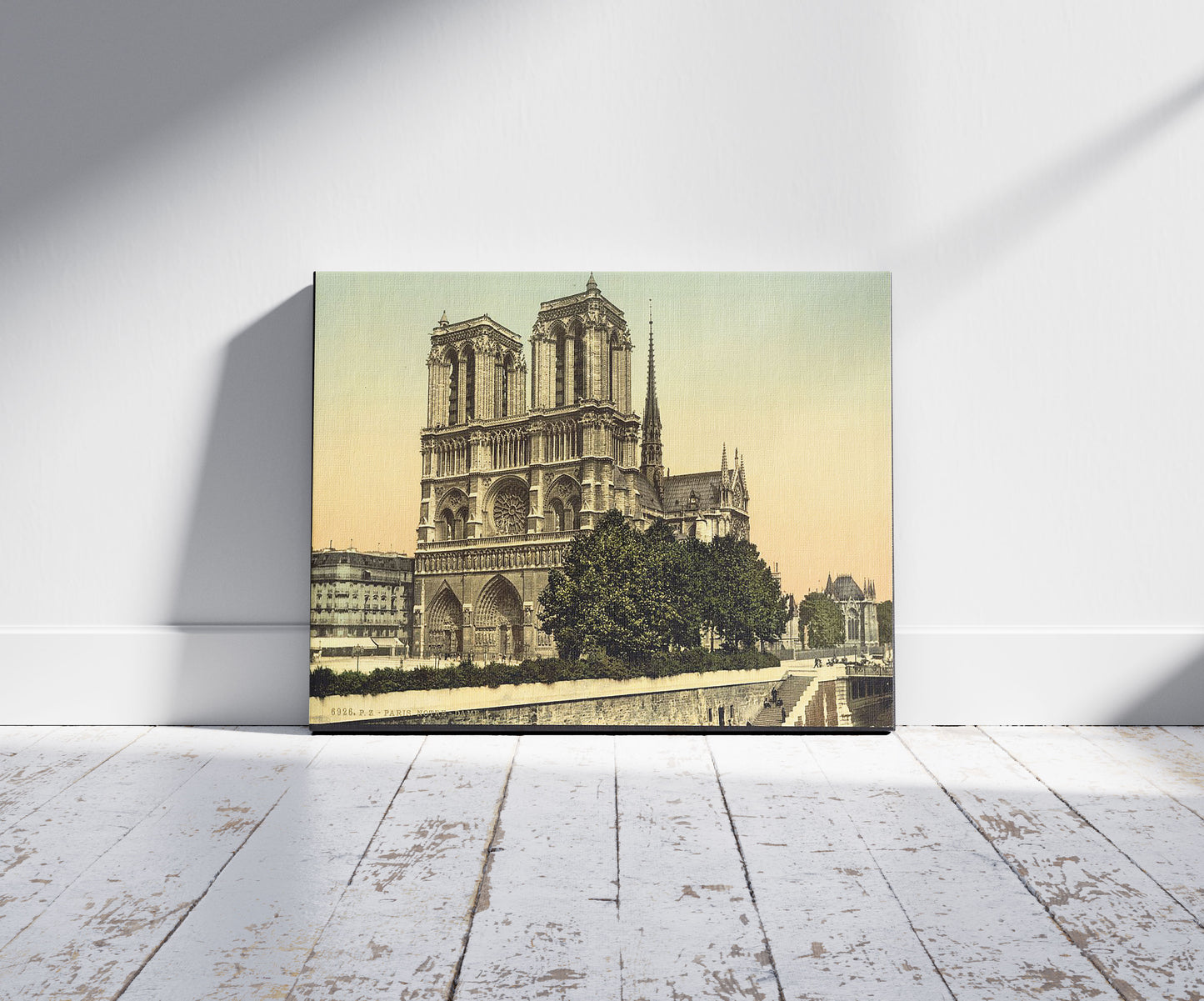 A picture of Notre Dame, Paris, France, a mockup of the print leaning against a wall