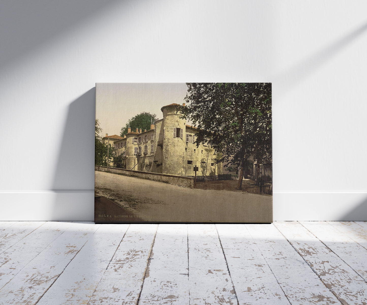 A picture of Old castle, Bayonne, Pyrenees, France, a mockup of the print leaning against a wall