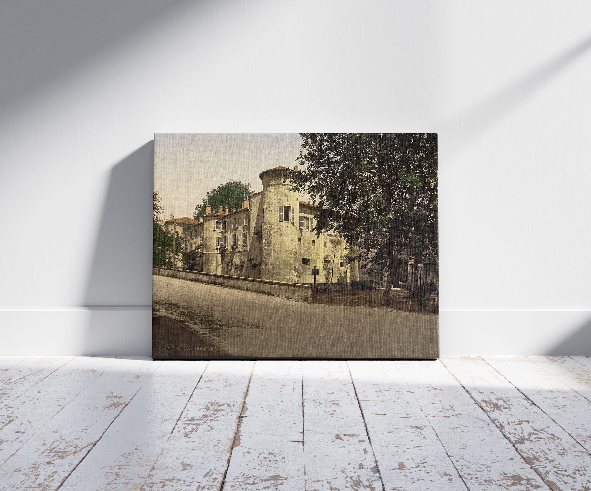 A picture of Old castle, Bayonne, Pyrenees, France, a mockup of the print leaning against a wall