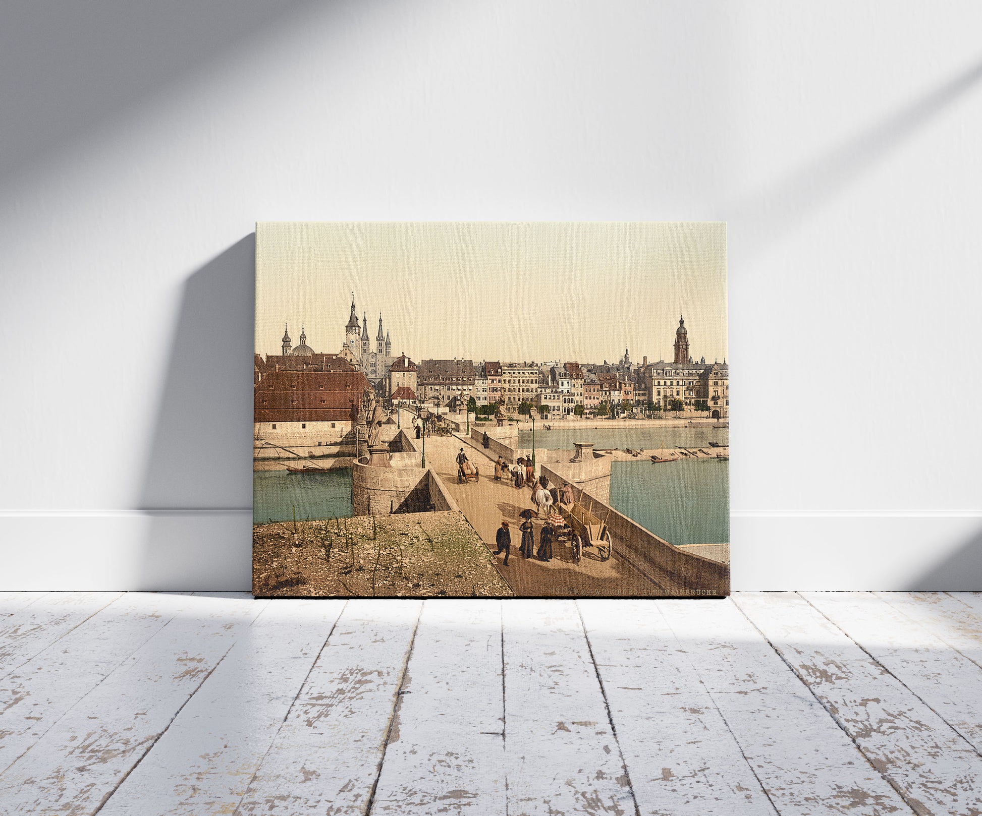 A picture of Old Main Bridge over Main River and town, Wurzburg, Bavaria, Germany, a mockup of the print leaning against a wall