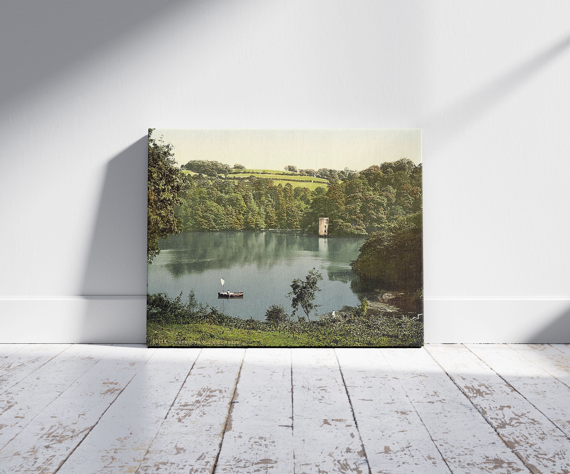 A picture of Old Mill Creek, Dartmouth, England, a mockup of the print leaning against a wall