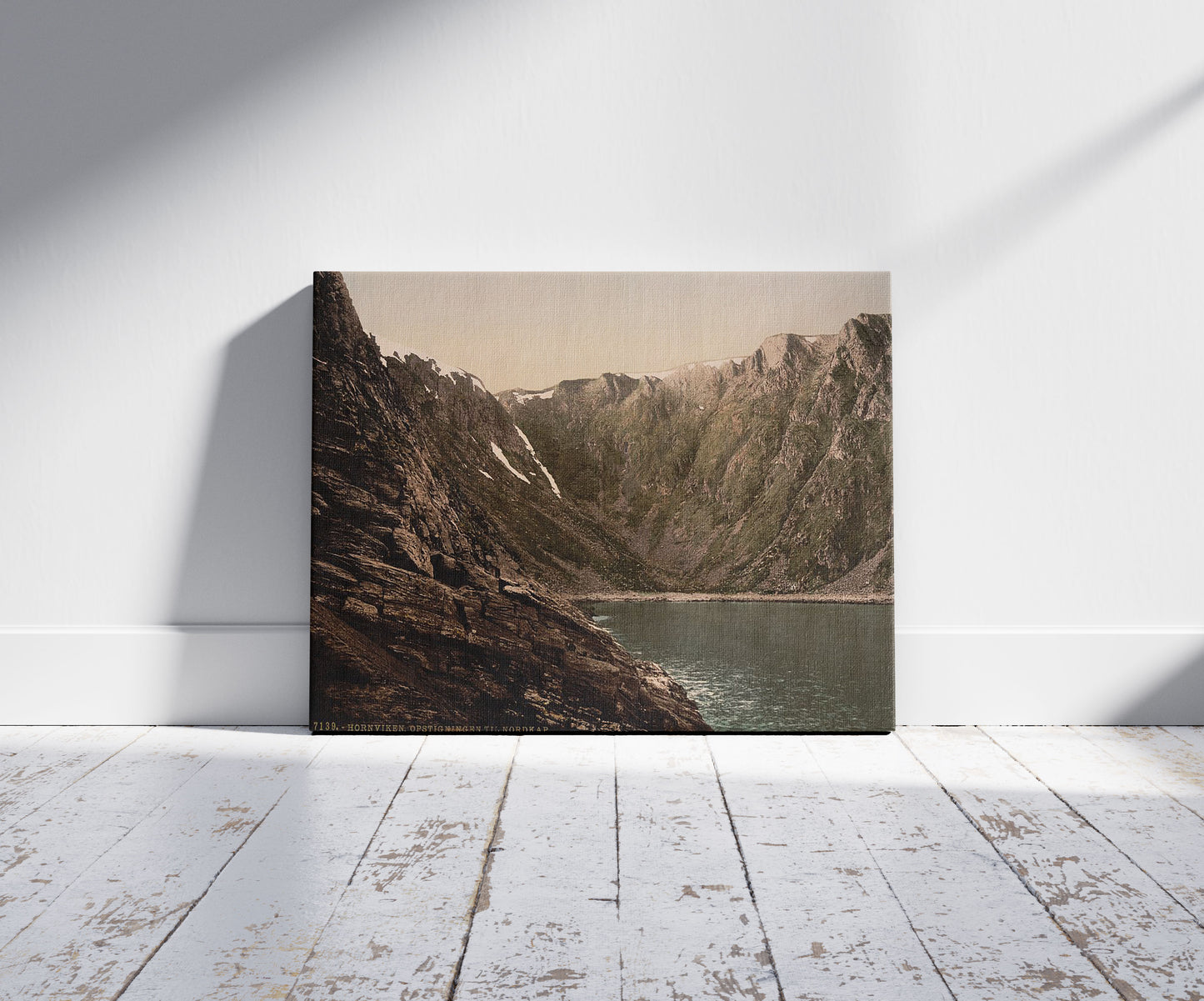 A picture of Opstigningen til Nordkap (i.e., Nordkapp), Hornviken, Norway, a mockup of the print leaning against a wall