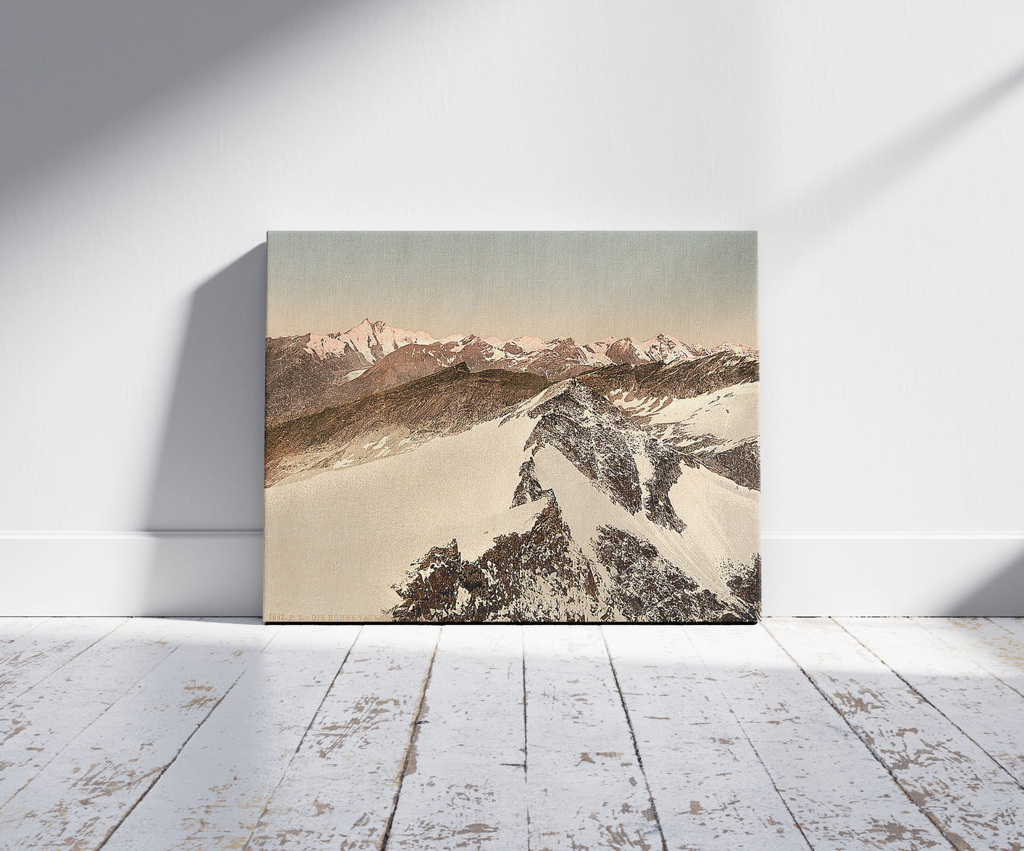 A picture of Ortler Territory, the Hohen Tauren (i.e., Hohentauern), seen from Sonnblick, Tyrol, Austro-Hungary, a mockup of the print leaning against a wall