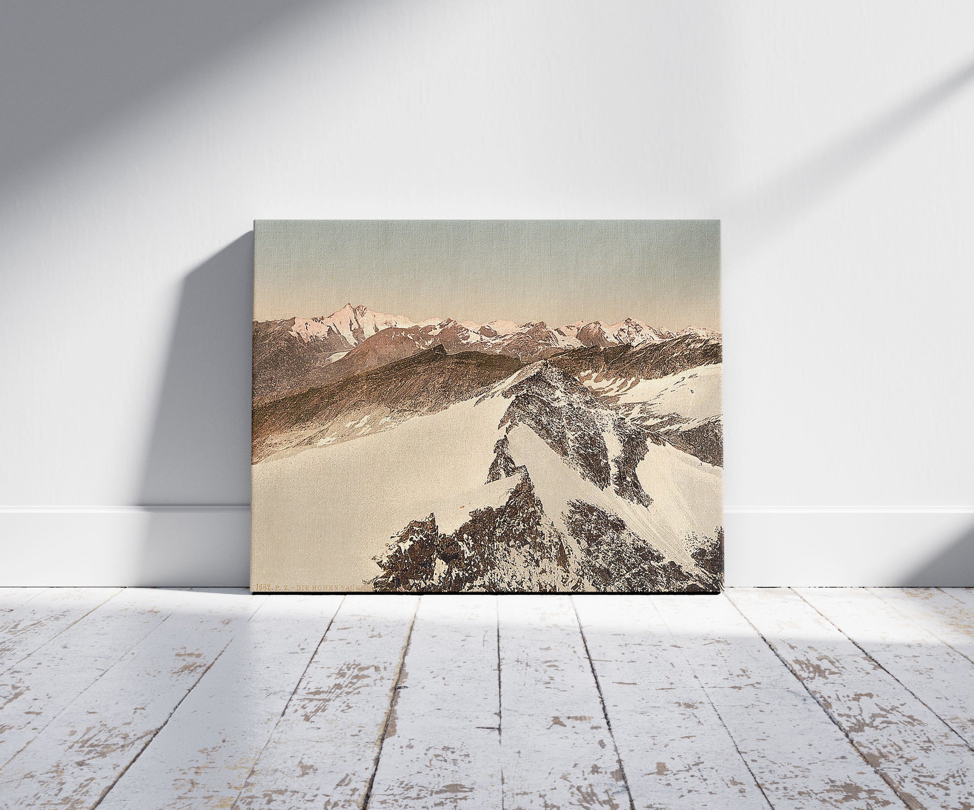 A picture of Ortler Territory, the Hohen Tauren (i.e., Hohentauern), seen from Sonnblick, Tyrol, Austro-Hungary, a mockup of the print leaning against a wall