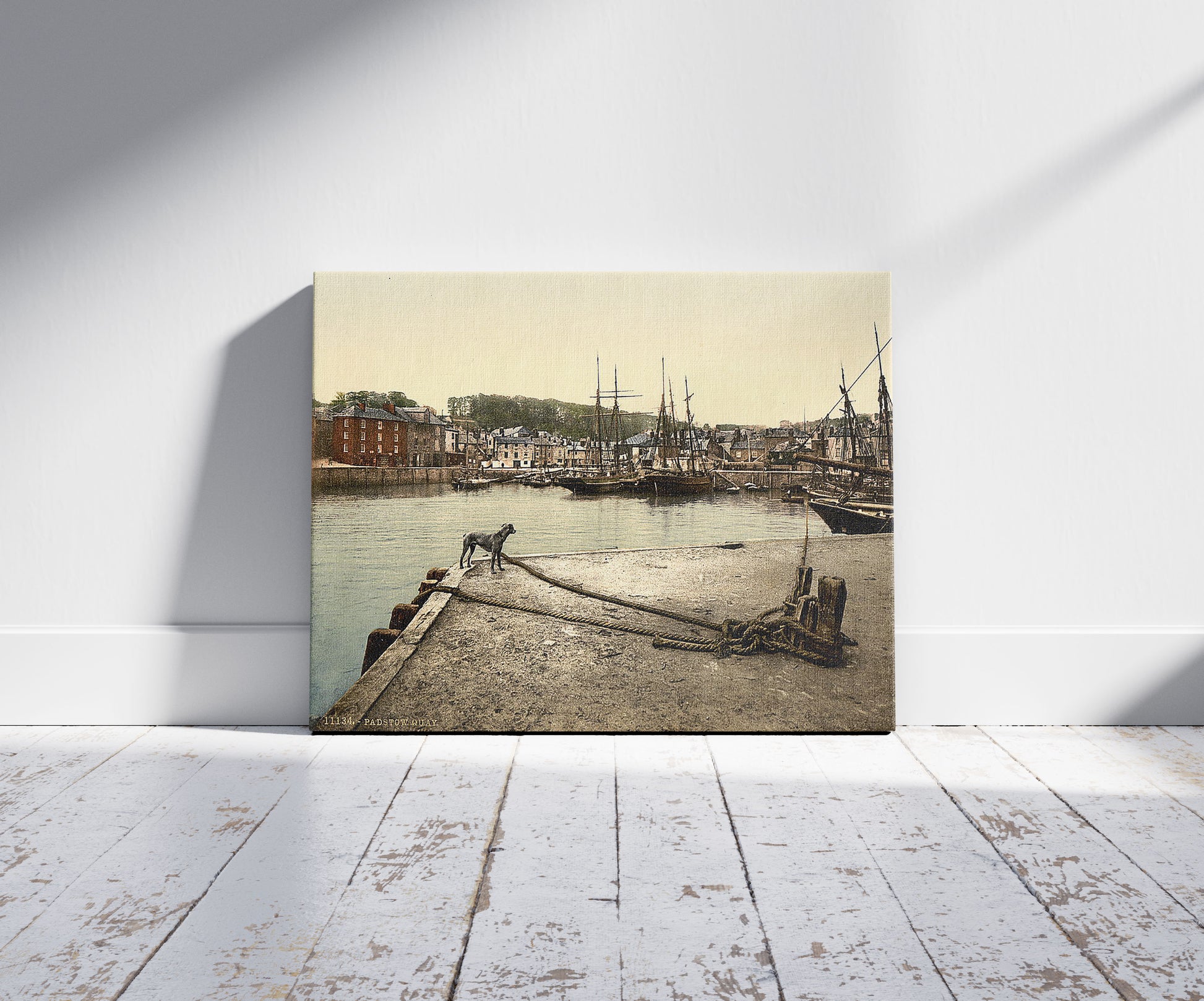 A picture of Padstow Quay, Cornwall, England, a mockup of the print leaning against a wall