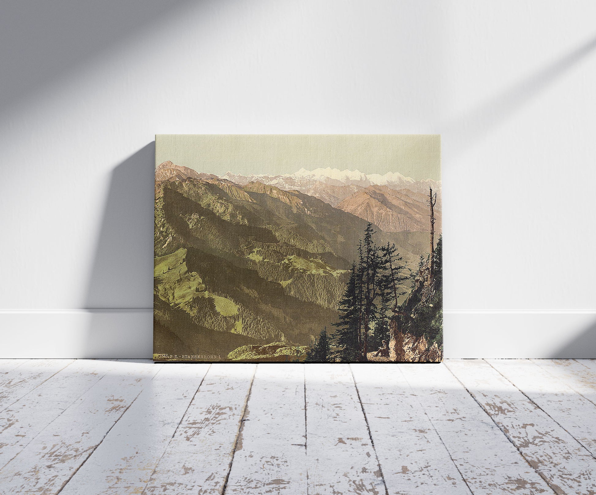 A picture of Panoramic view towards Oberland, Stanserhorn Switzerland, a mockup of the print leaning against a wall