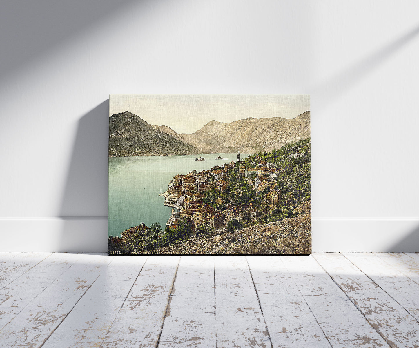 A picture of Perasto, general view, showing island, Dalmatia, Austro-Hungary, a mockup of the print leaning against a wall