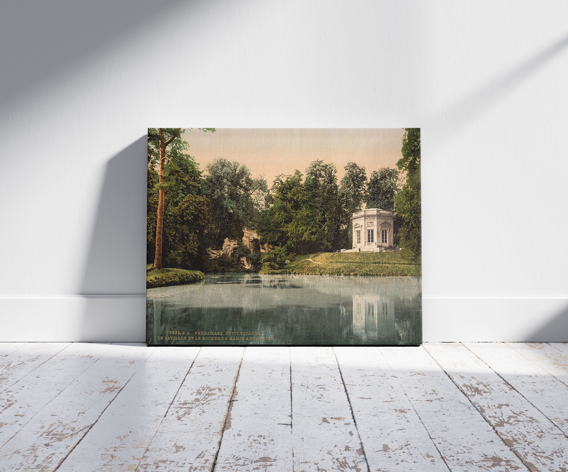 A picture of Petit Trianon, the Pavillion and the Rock of Marie Antoinette, Versailles, France, a mockup of the print leaning against a wall