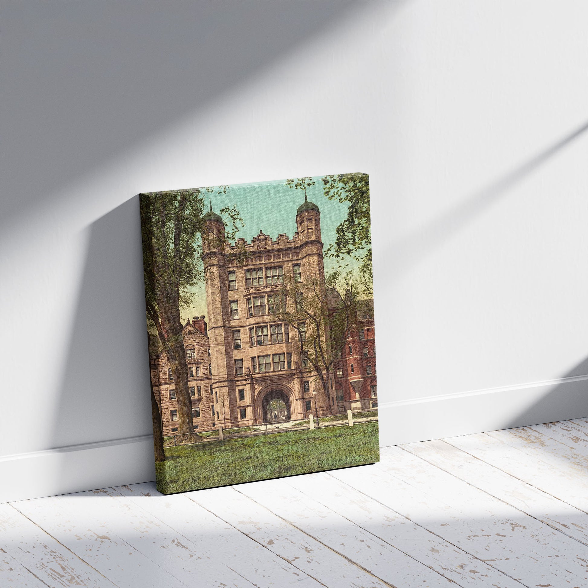 A picture of Phelps Hall and gateway, Yale College, a mockup of the print leaning against a wall