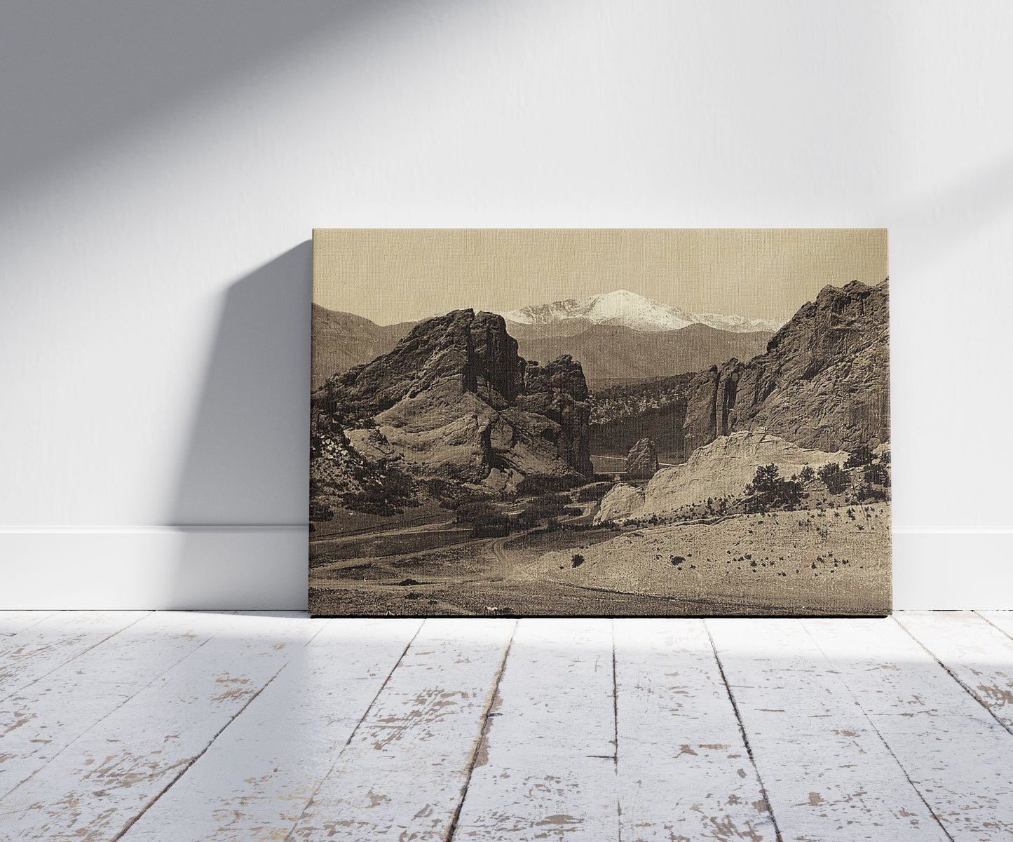 A picture of Pike's Peak from the Garden of the Gods, a mockup of the print leaning against a wall