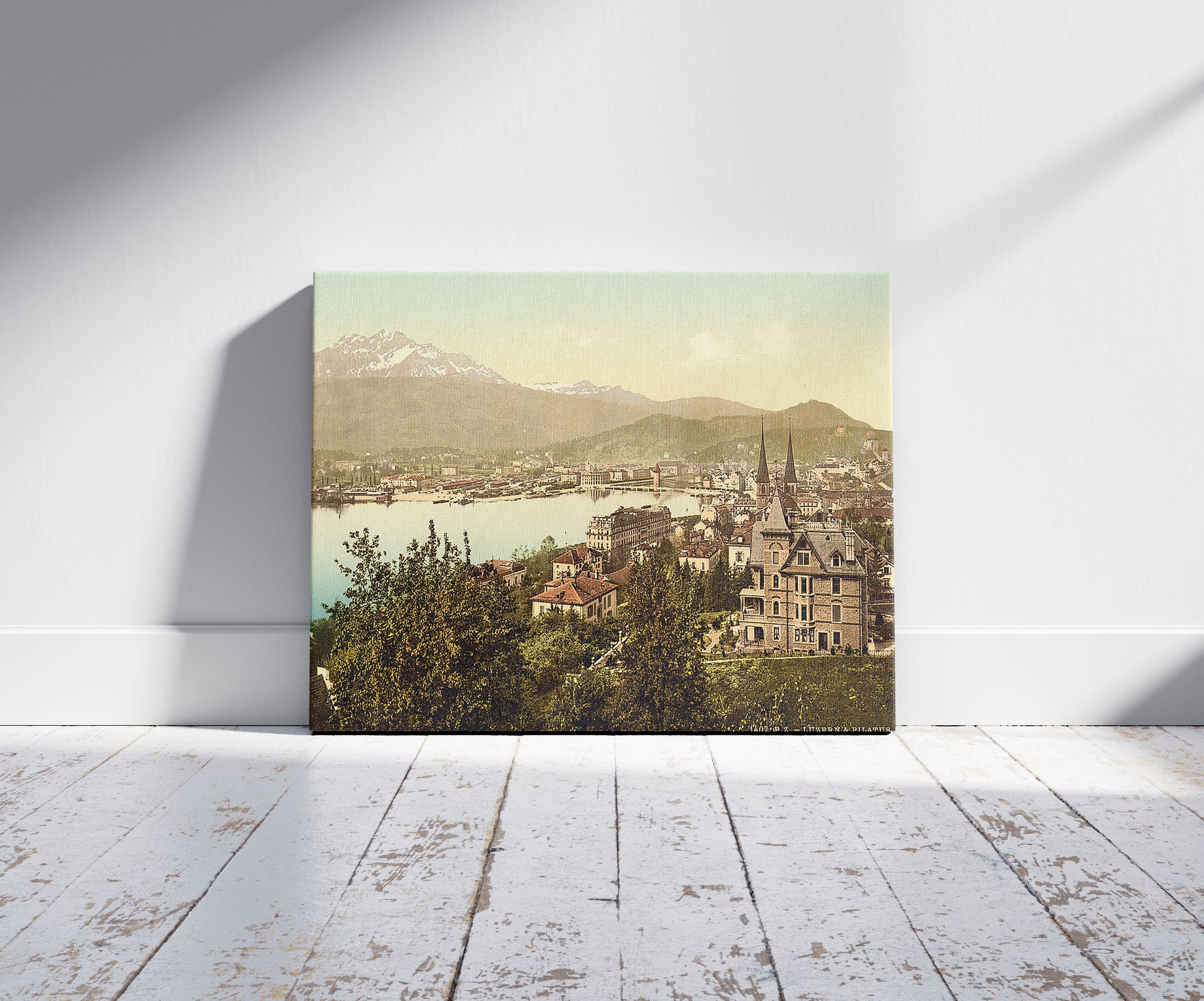 A picture of Pilatus and Lucerne, seen from Neuschweizerhaus, Lucerne, Switzerland, a mockup of the print leaning against a wall
