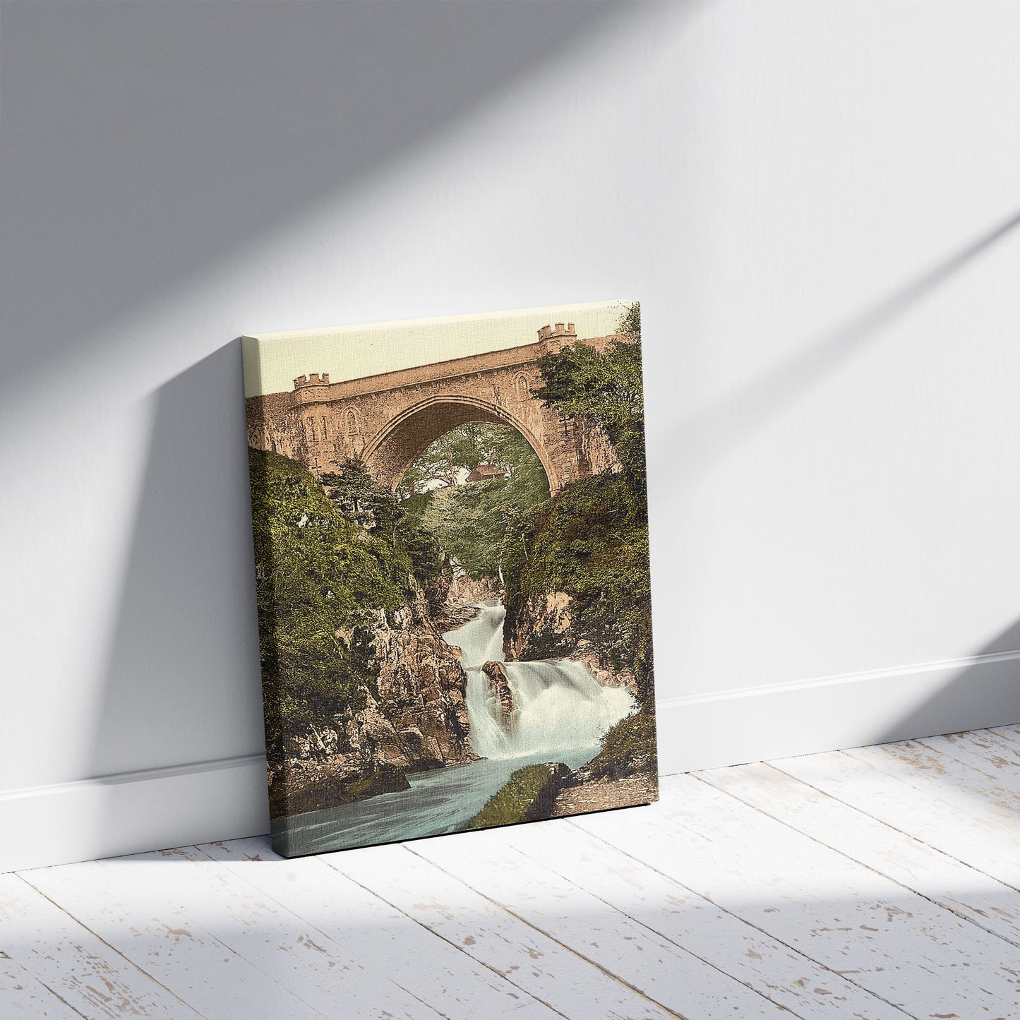 A picture of Poulaphuca Fall. County Wicklow, Ireland, a mockup of the print leaning against a wall