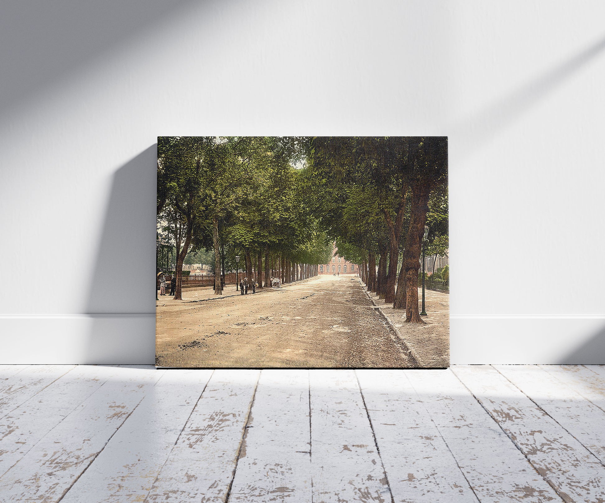 A picture of Promenade looking towards Queen's Hotel, Cheltenham, England, a mockup of the print leaning against a wall