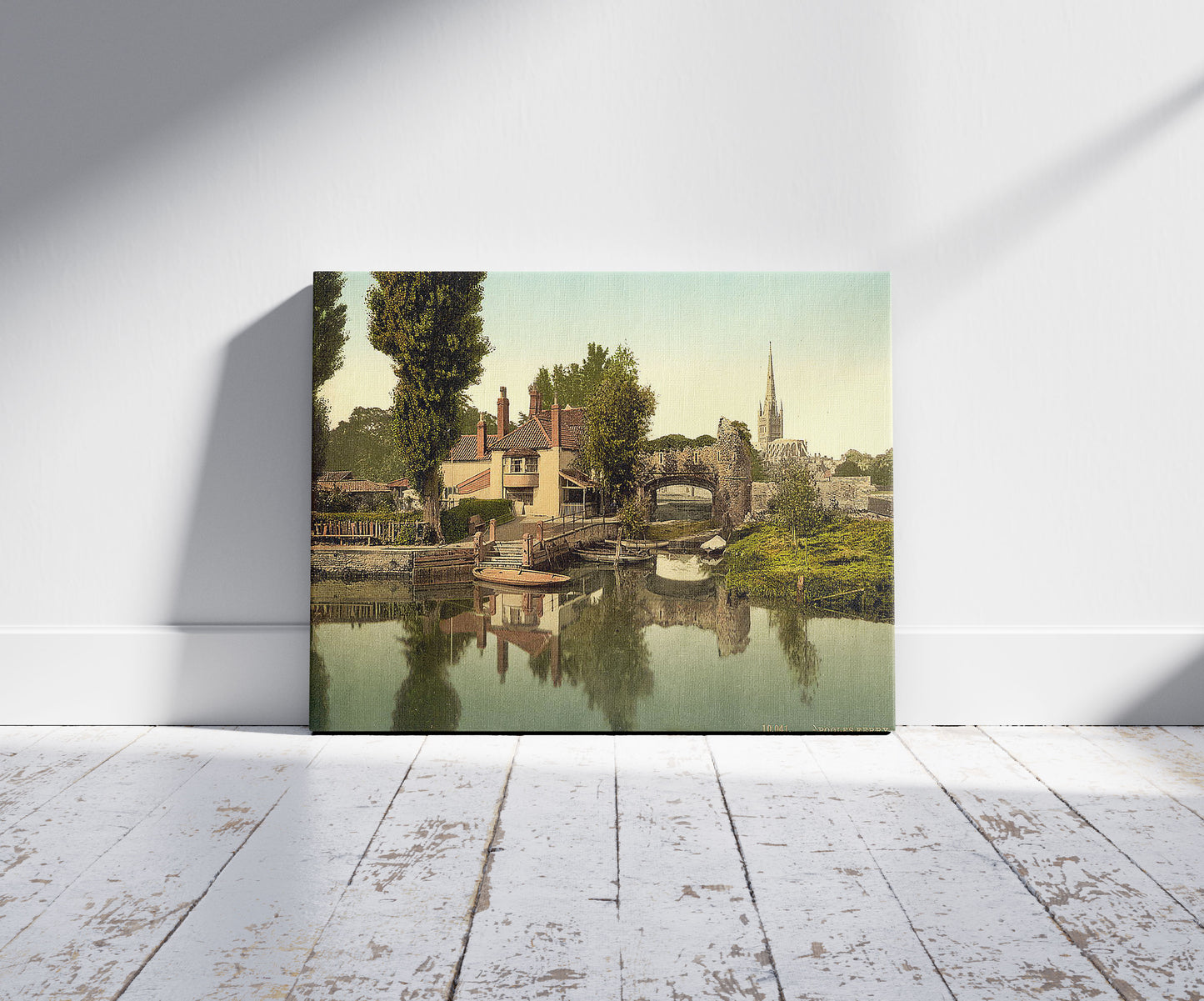 A picture of Pulls Ferry, Norwich, England, a mockup of the print leaning against a wall