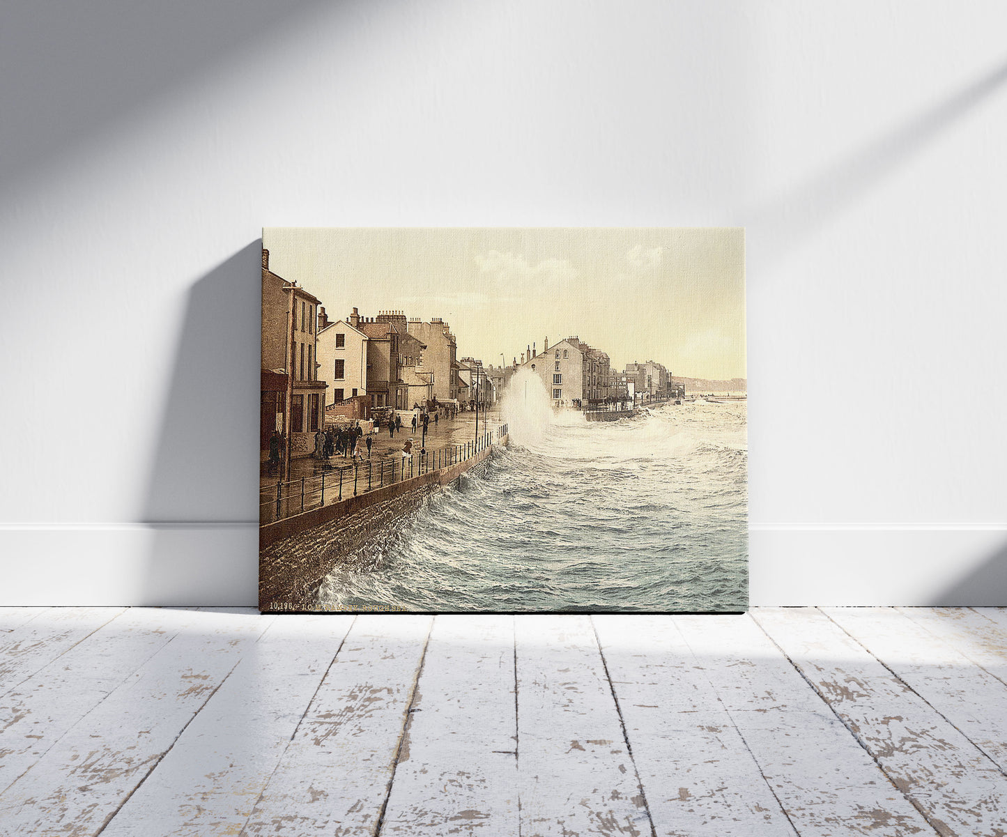 A picture of Ramsey, rough sea, Isle of Man, a mockup of the print leaning against a wall