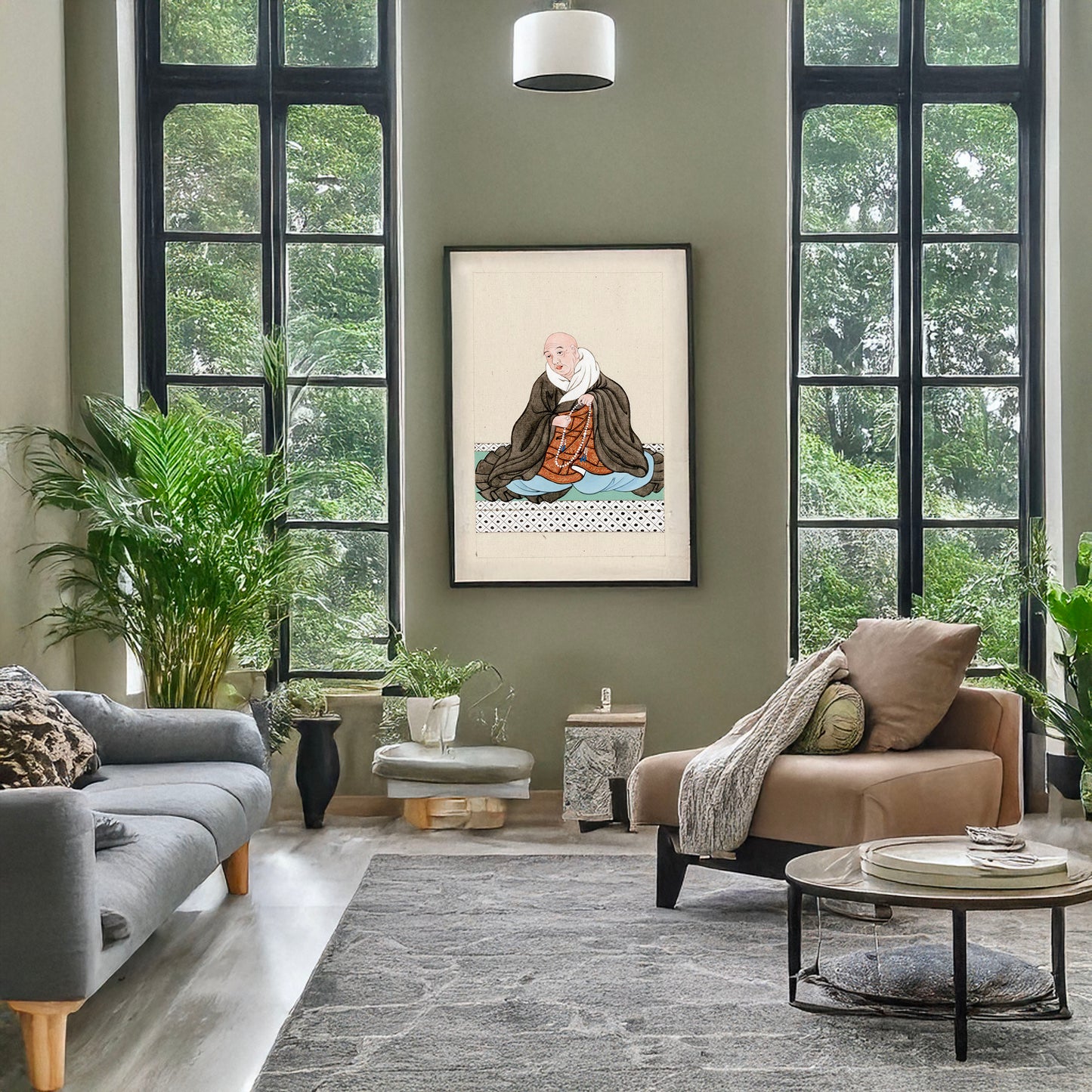 A picture of Religious figure, probably a monk, seated, facing slightly left, holding a loop of prayer beads, a mockup of the print leaning against a wall