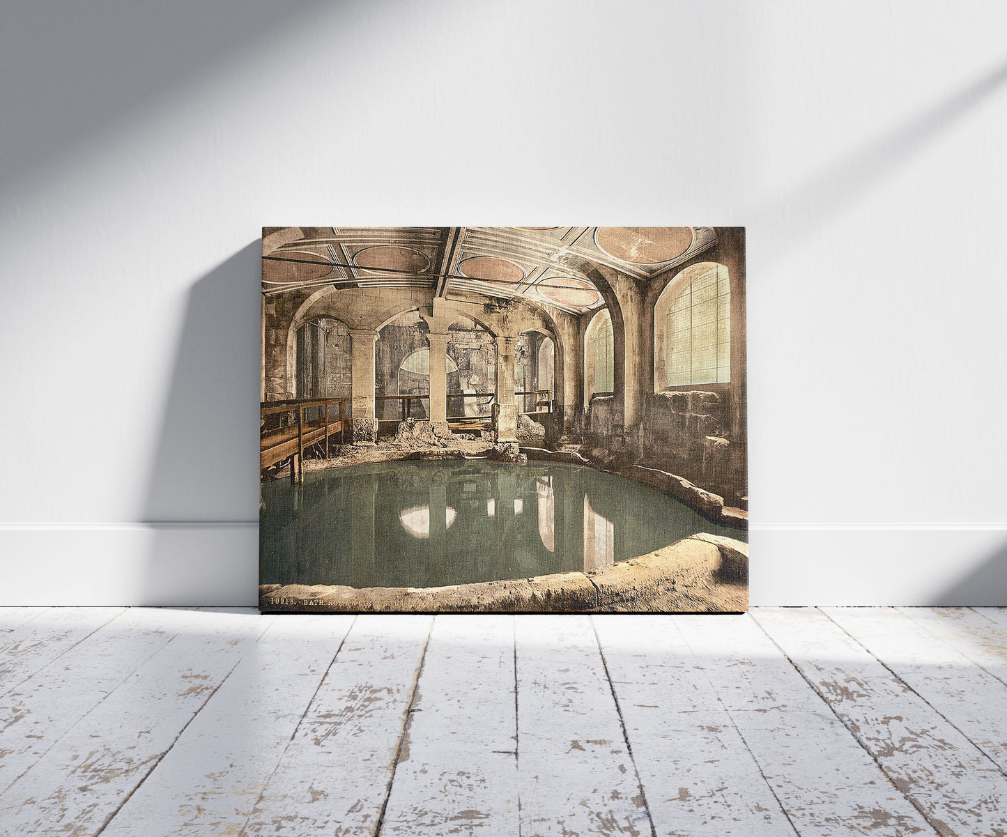 A picture of Roman Baths and Abbey, Circular Bath, Bath, England, a mockup of the print leaning against a wall