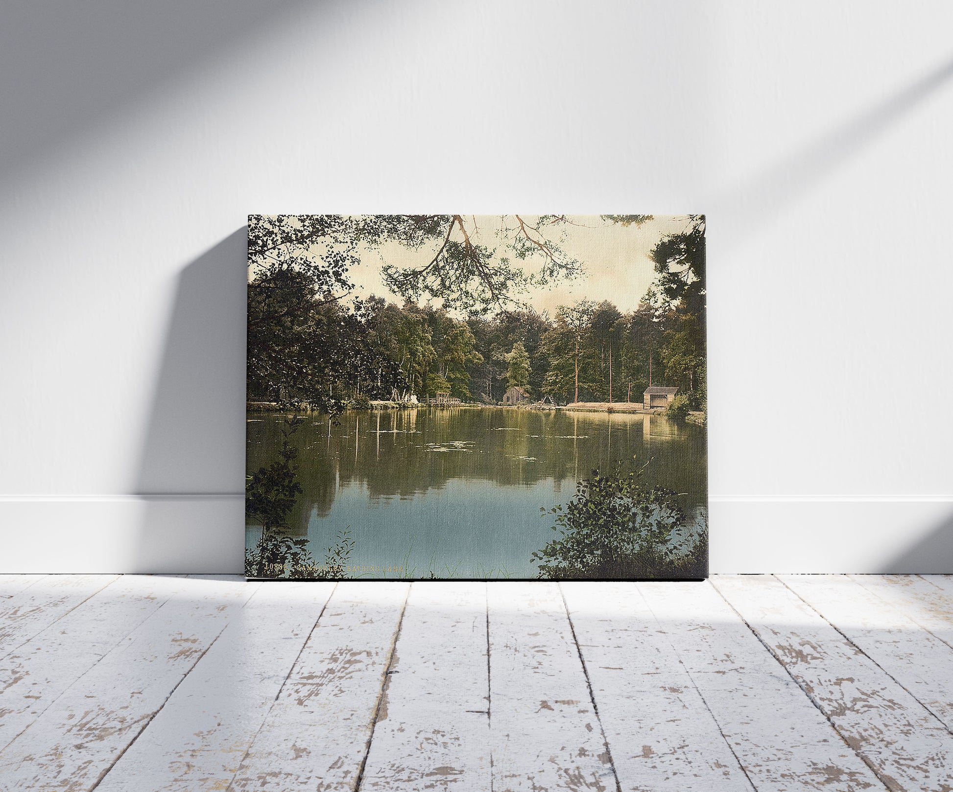 A picture of Royal Military College, bathing lake, Sandhurst, Camberley, England, a mockup of the print leaning against a wall