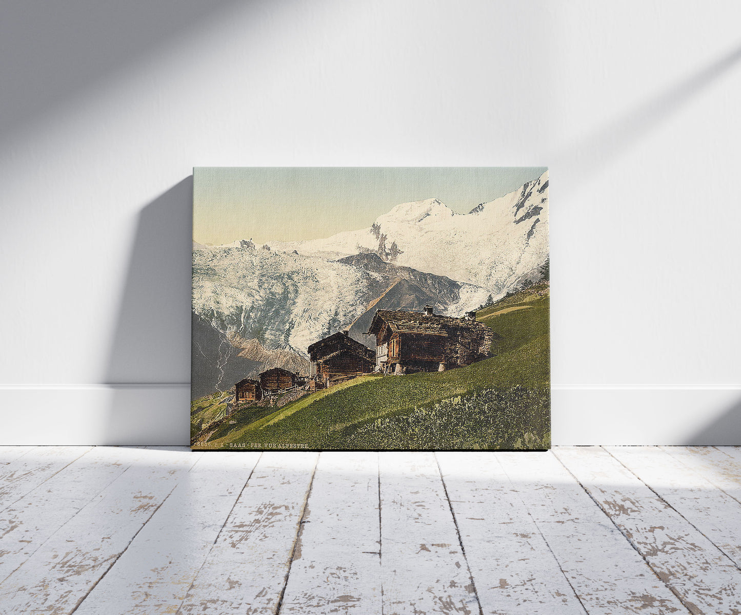A picture of Saas Fee, alpine view, Valais, Alps of, Switzerland, a mockup of the print leaning against a wall