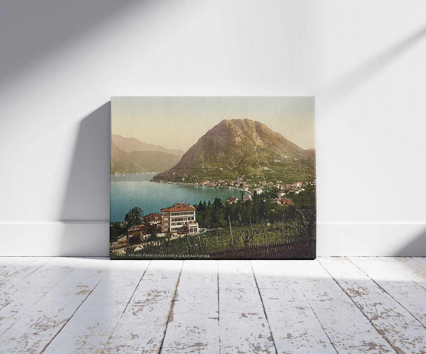 A picture of San Salvatore and Paradiso, Tessin, Switzerland, a mockup of the print leaning against a wall