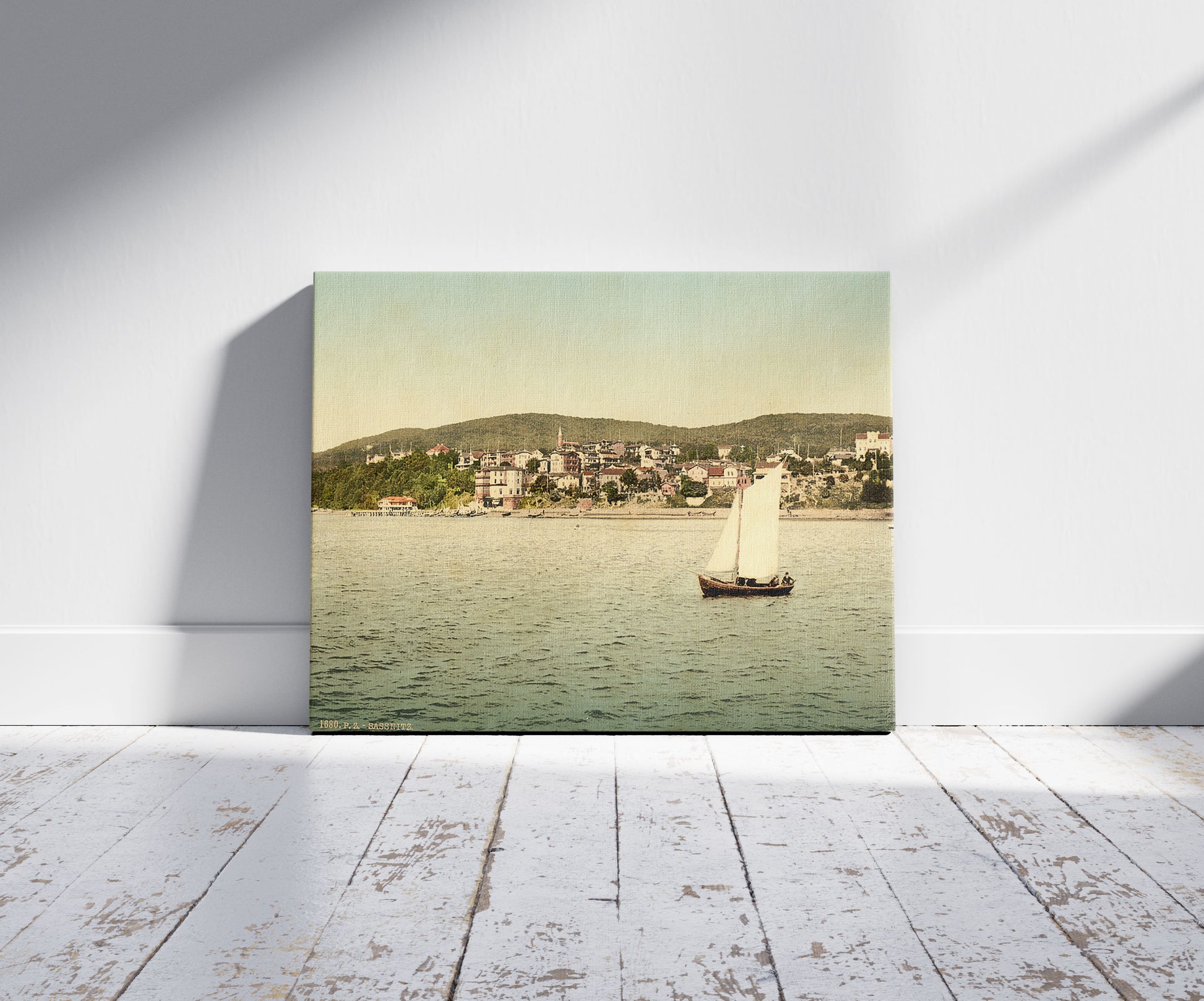 A picture of Sassnitz, seen from the water, Isle of Rugen, Germany, a mockup of the print leaning against a wall