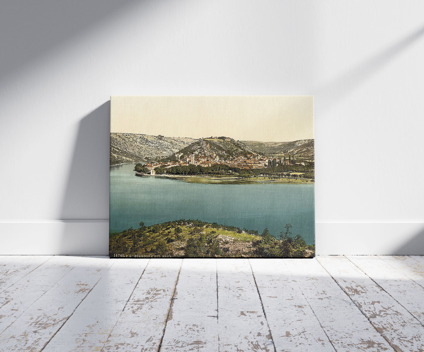 A picture of Scardona, upon the Kerka, Dalmatia, Austro-Hungary, a mockup of the print leaning against a wall