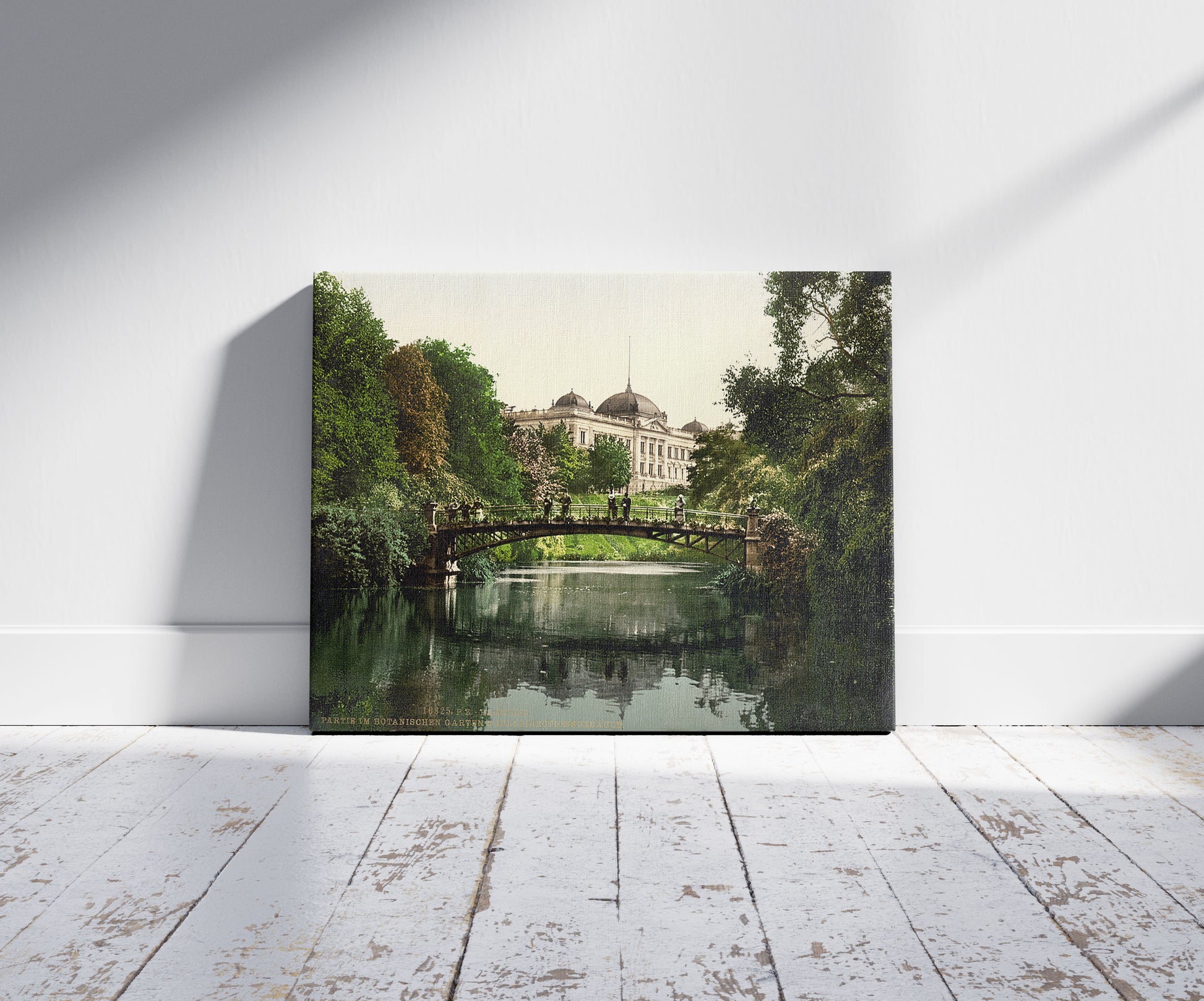 A picture of Scene in the Botanical Gardens with Director of Customs Building, Hamburg, Germany, a mockup of the print leaning against a wall
