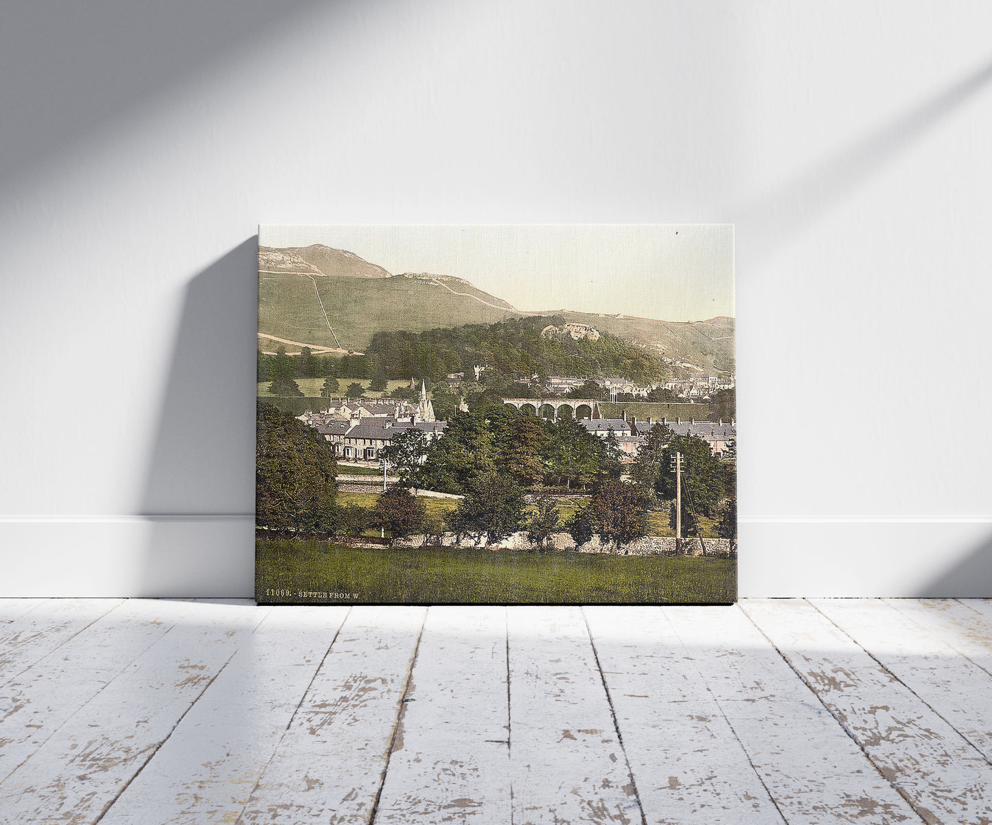 A picture of Settle, from west, Yorkshire, England, a mockup of the print leaning against a wall