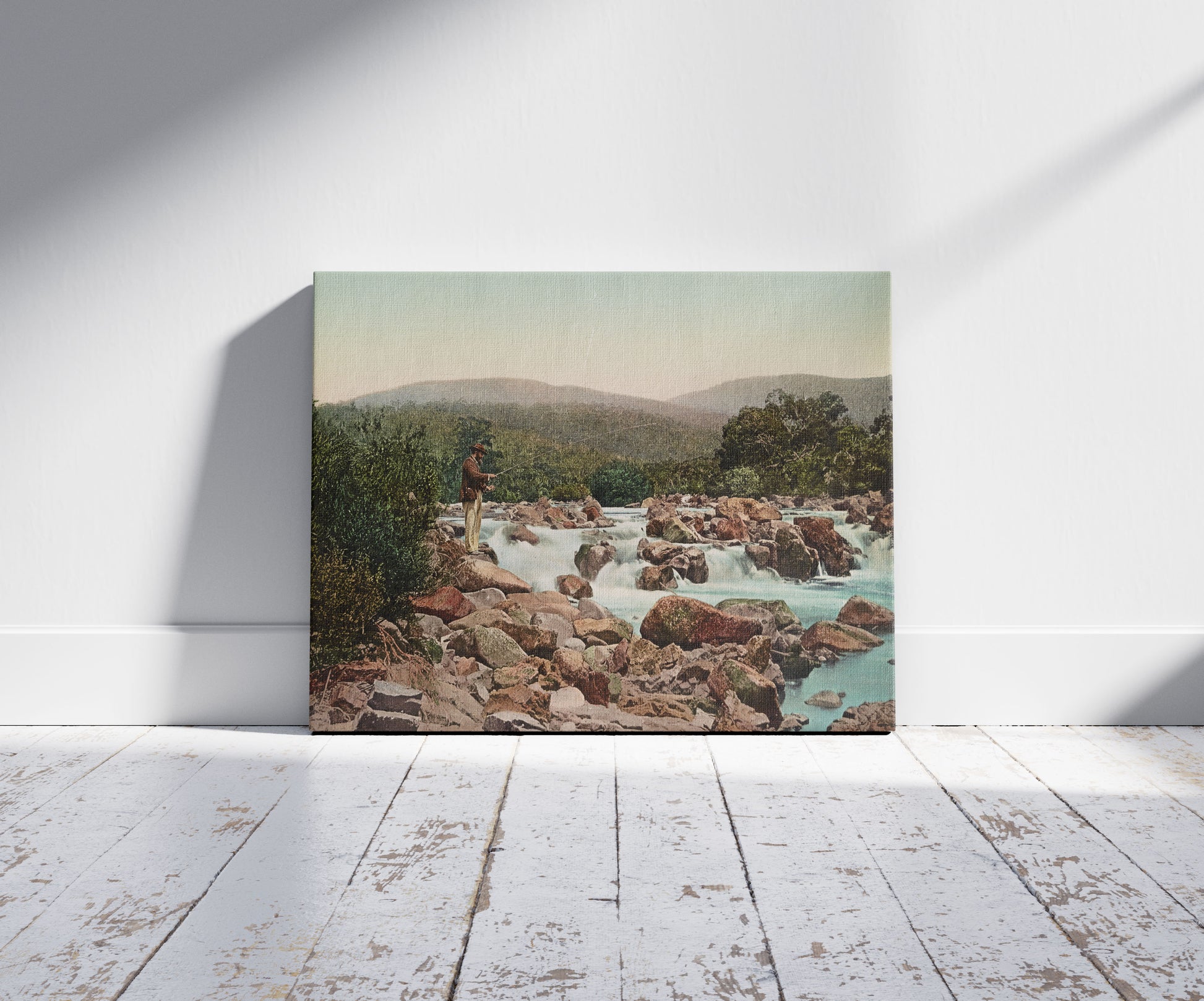 A picture of Spencer's Falls, Upper Snowy River, N.S.W., a mockup of the print leaning against a wall