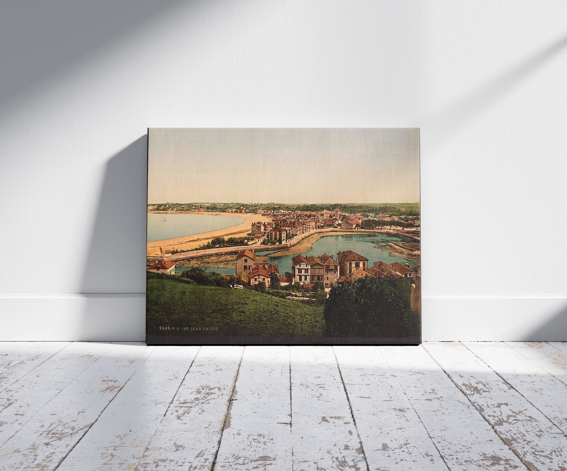 A picture of St. Jean de Luz and harbor, Pyrenees, France, a mockup of the print leaning against a wall
