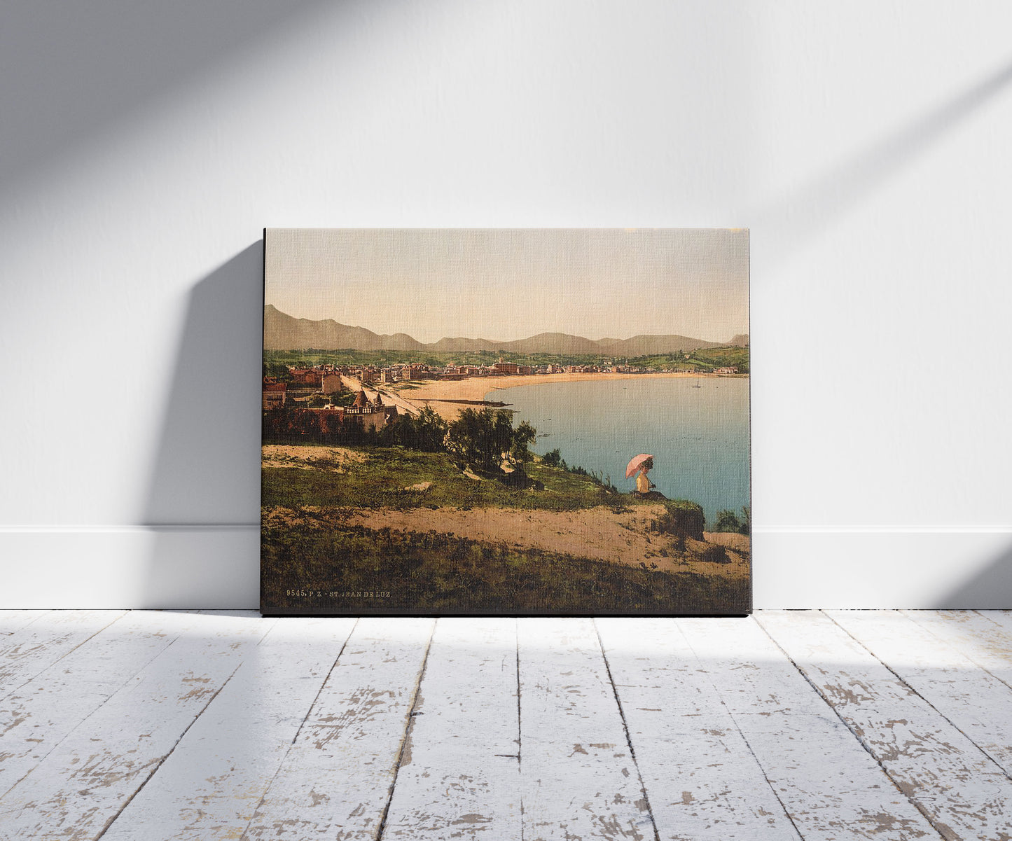 A picture of St. Jean de Luz, from Ste. Barbe, Pyrenees, France, a mockup of the print leaning against a wall