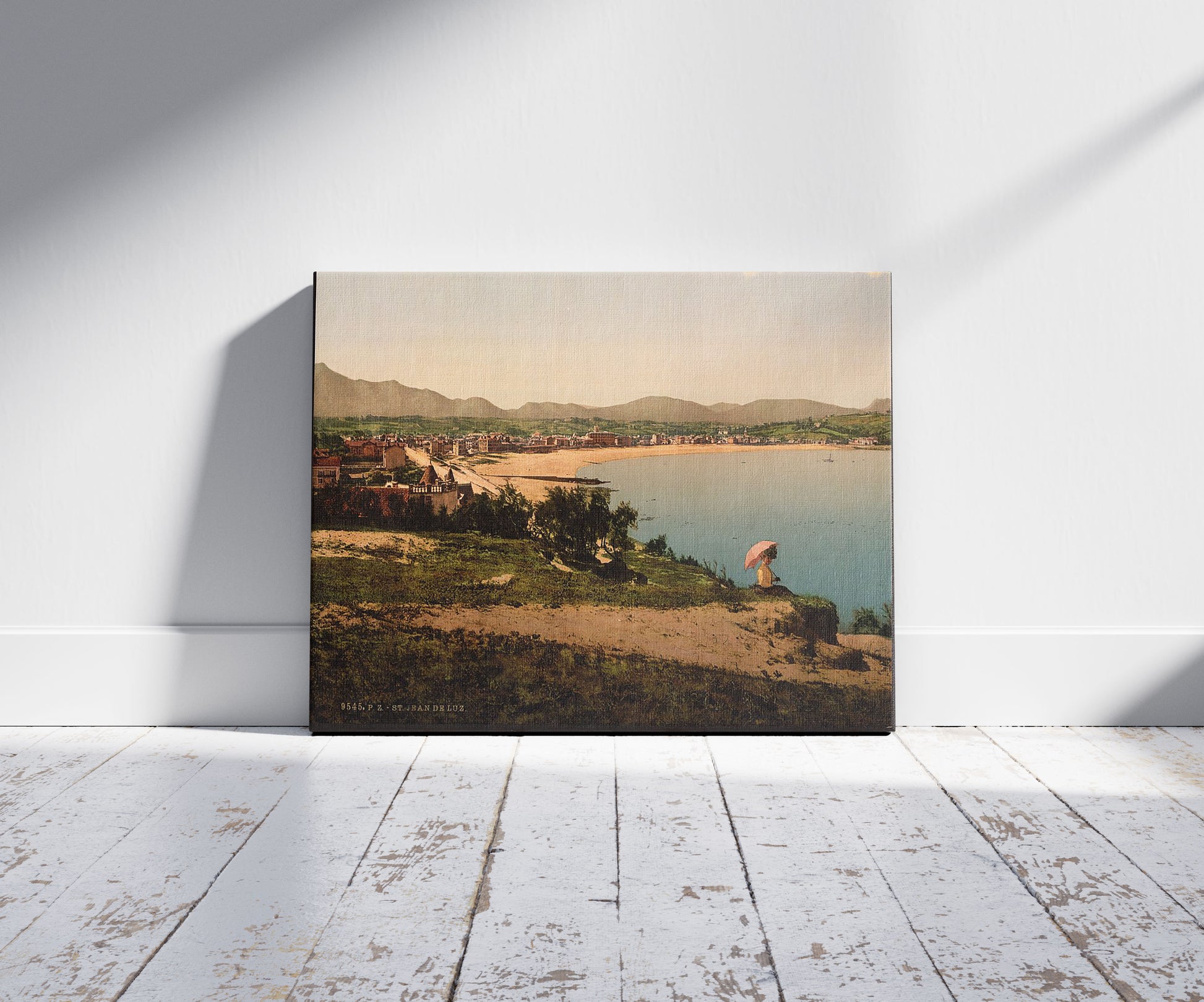 A picture of St. Jean de Luz, from Ste. Barbe, Pyrenees, France, a mockup of the print leaning against a wall